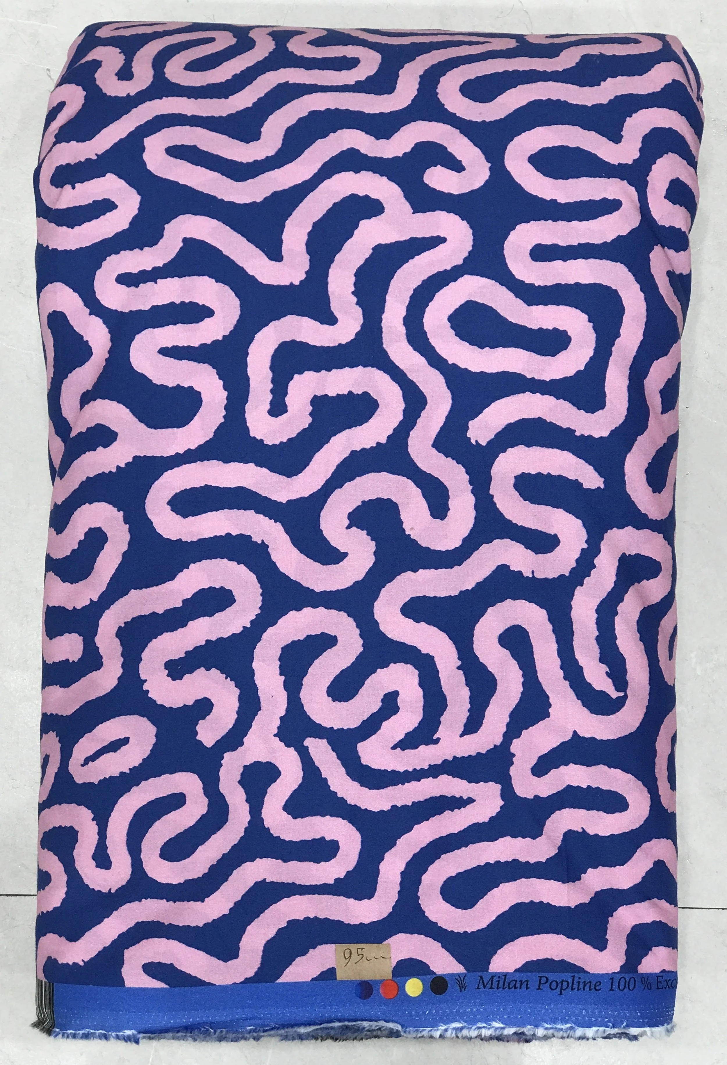 Vibrant royal blue background featuring an intricate, meandering abstract maze-like or doodle-inspired line pattern in a soft pastel pink hue.