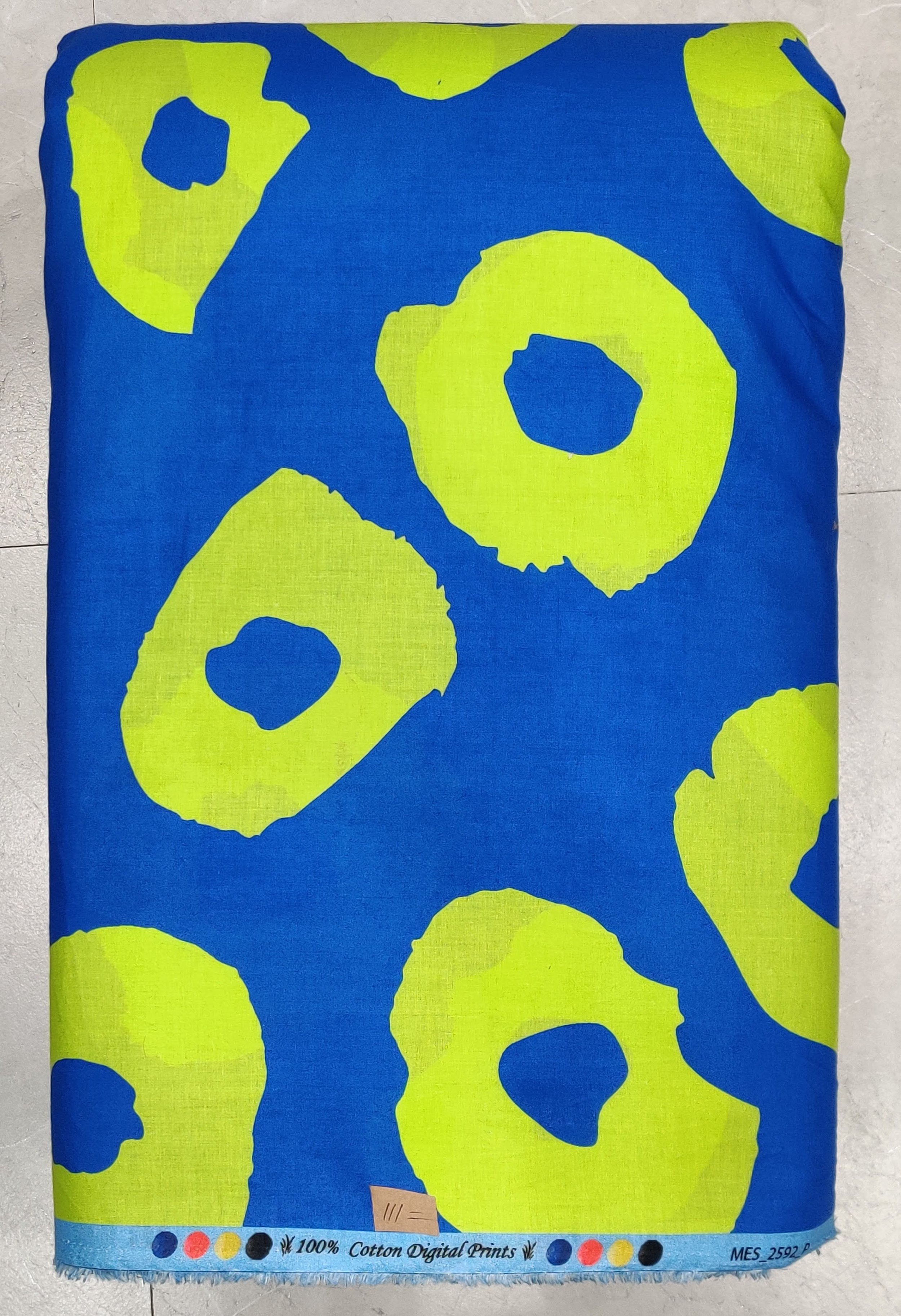 Vibrant blue and lime green abstract spot print offering a bold, playful vibe for contemporary fashion designs.