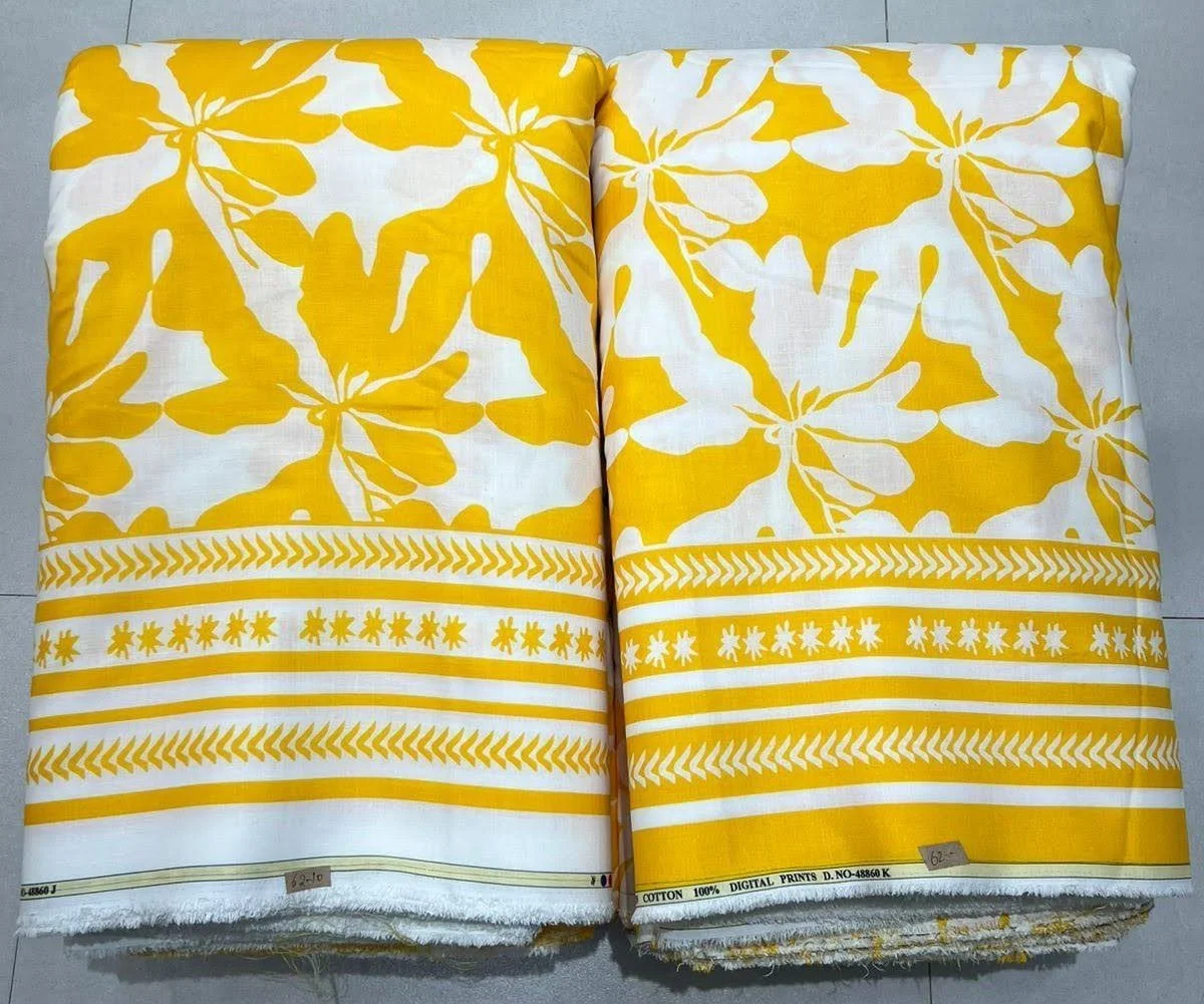 Sunlit golden-yellow and pristine ivory all-over fabric featuring a radiant floral and botanical block-print pattern, detailed with a matching striped hemline border designed for premium ethnic apparel and coordinated co-ord sets.