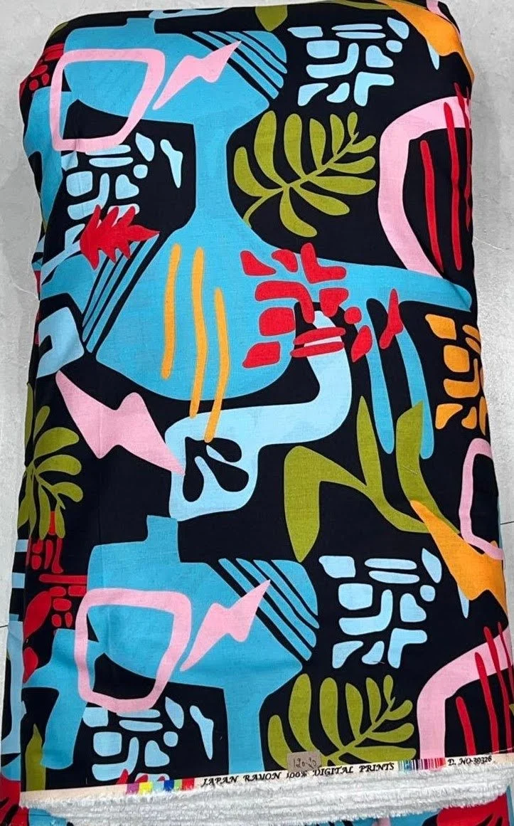 Dynamic multi-hued textile showcasing a bold pop-art motif with stylized facial artwork, geometric blocking, and vibrant golden-yellow, azure, and black shades.