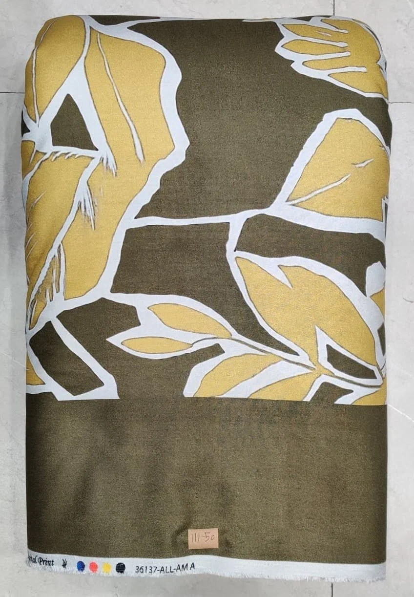 Rich golden-amber and deep olive-green fabric featuring a large-scale abstract botanical composition with sweeping curved leaves, fluid organic shapes, and a smooth dual-tone contrast.