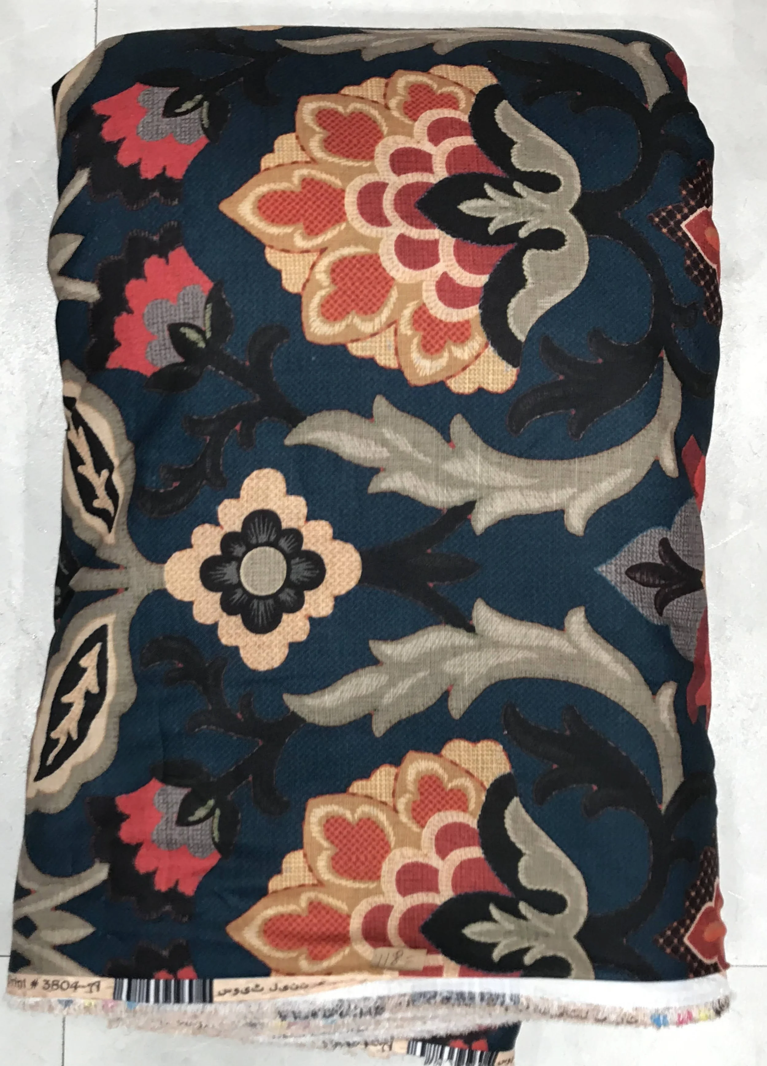 Deep midnight-blue and vintage-coral fabric featuring an ornate baroque medallion layout with symmetrical scrolling floral elements, traditional Paisley motifs, and rich antique framing.