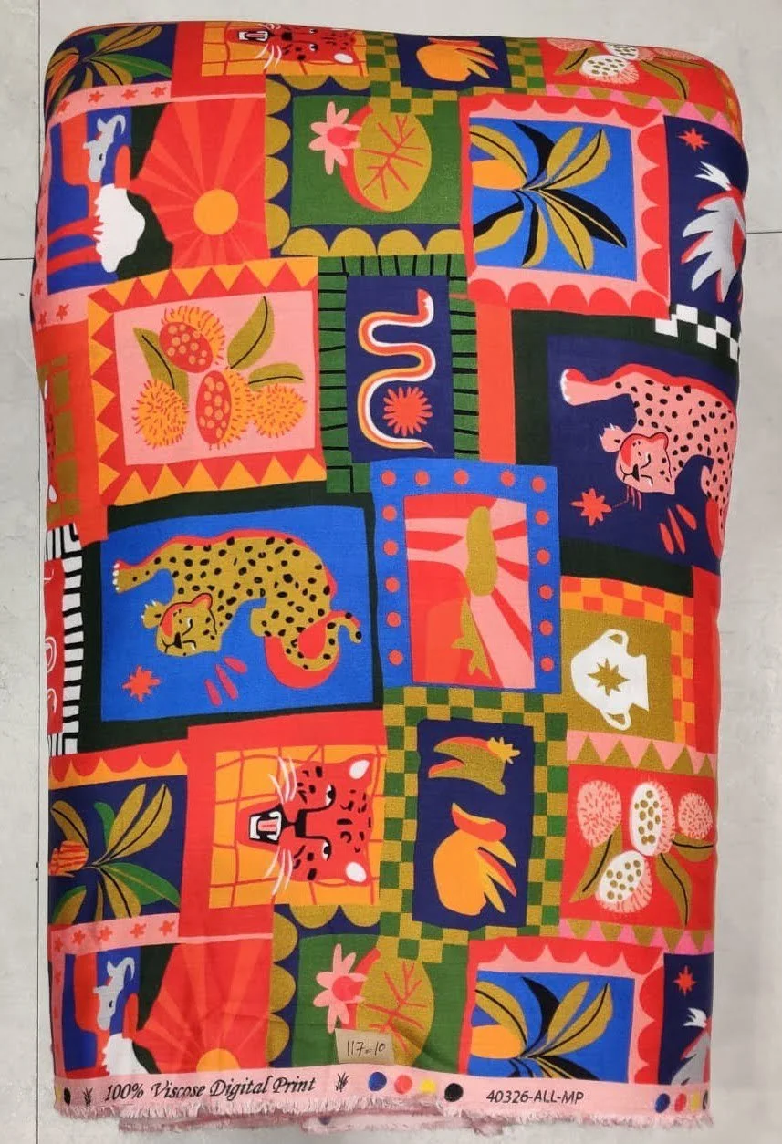 Rich magenta-pink and deep plum-purple silk featuring an abstract patchwork motif composed of contrasting color blocks, graphic floral emblems, and intricate folk art borders.