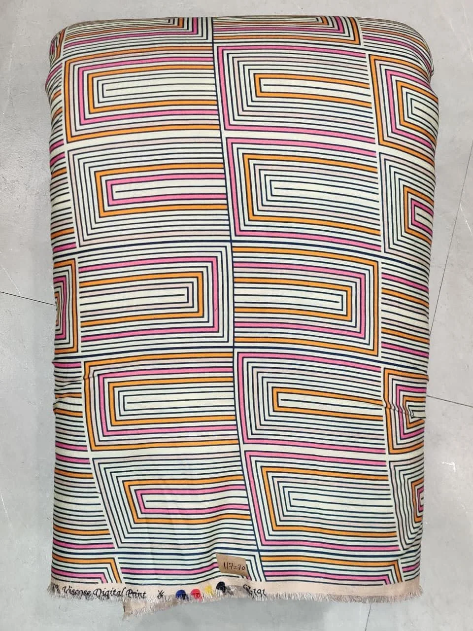 Luminous multi-hued pastel and slate-grey woven fabric displaying a geometric architectural motif featuring neat parallel line bands, stacked rectangular panels, and clean chromatic color blocks.