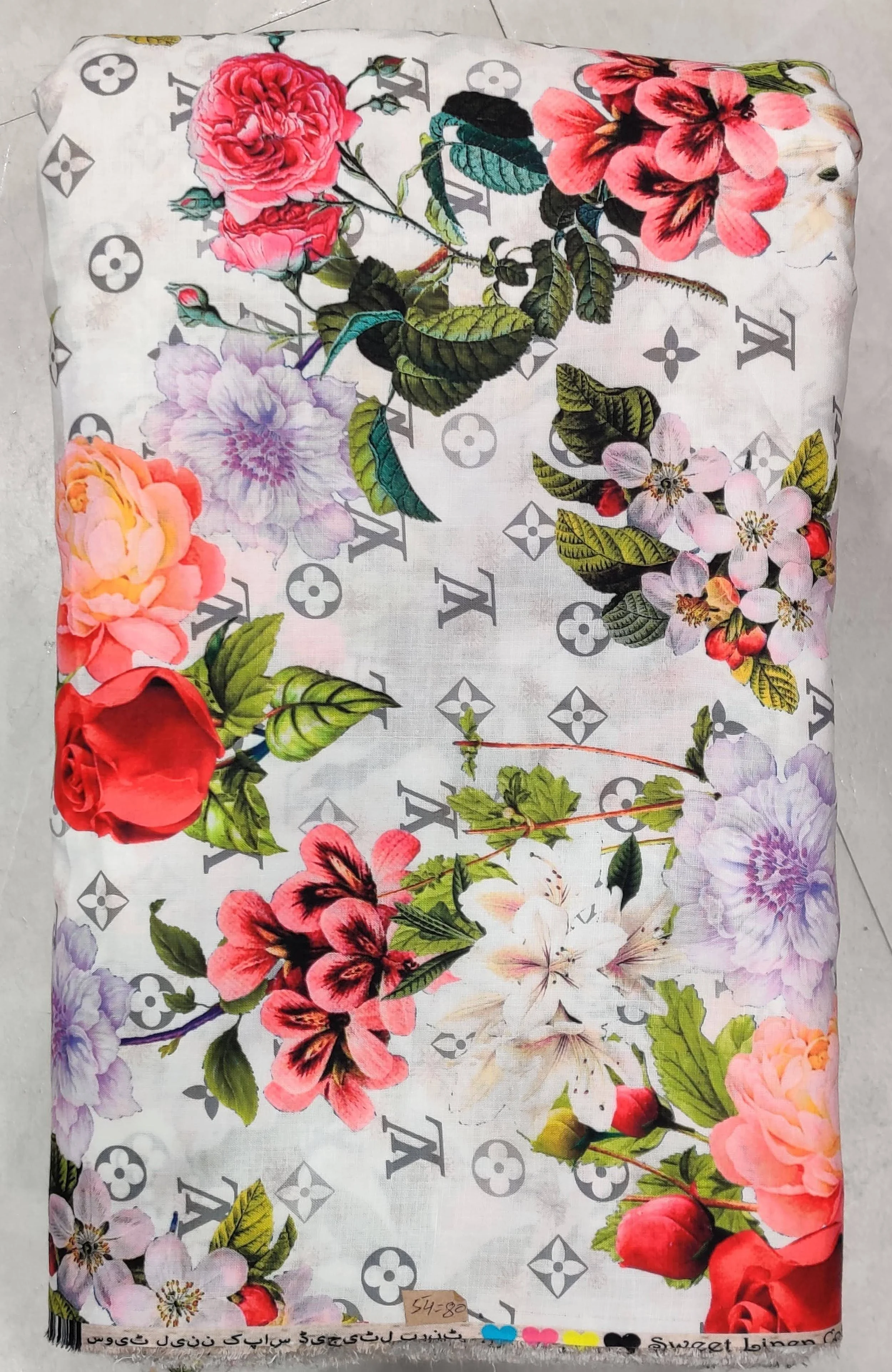Luxurious ivory-white and pastel-pink all-over fabric featuring a delicate watercolor floral print, interspersed with subtle monogram accents and blooming peonies for premium apparel.