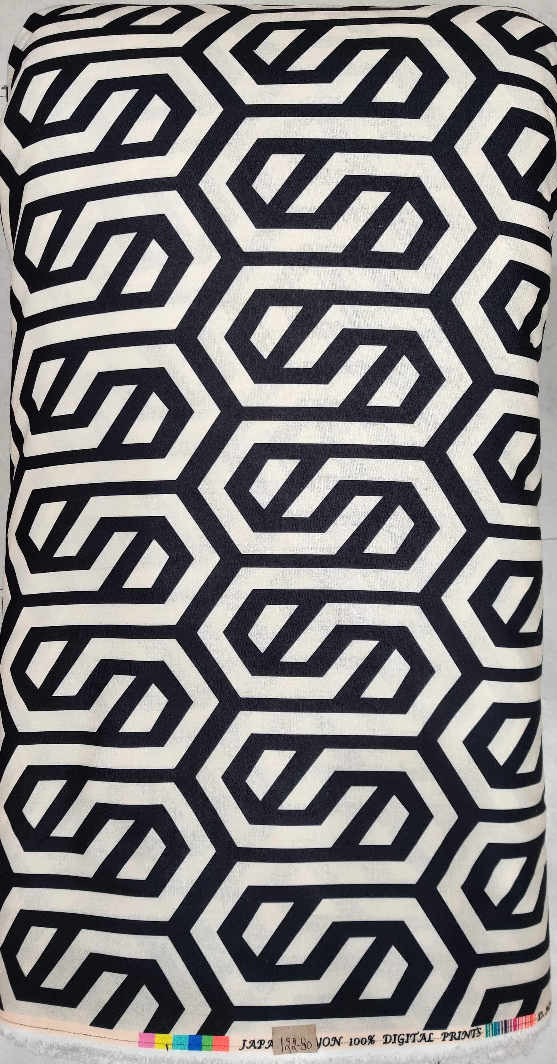 Glossy white material displaying a vibrant tropical jungle motif with dense green palm leaves, exotic flora, and colorful wildlife.