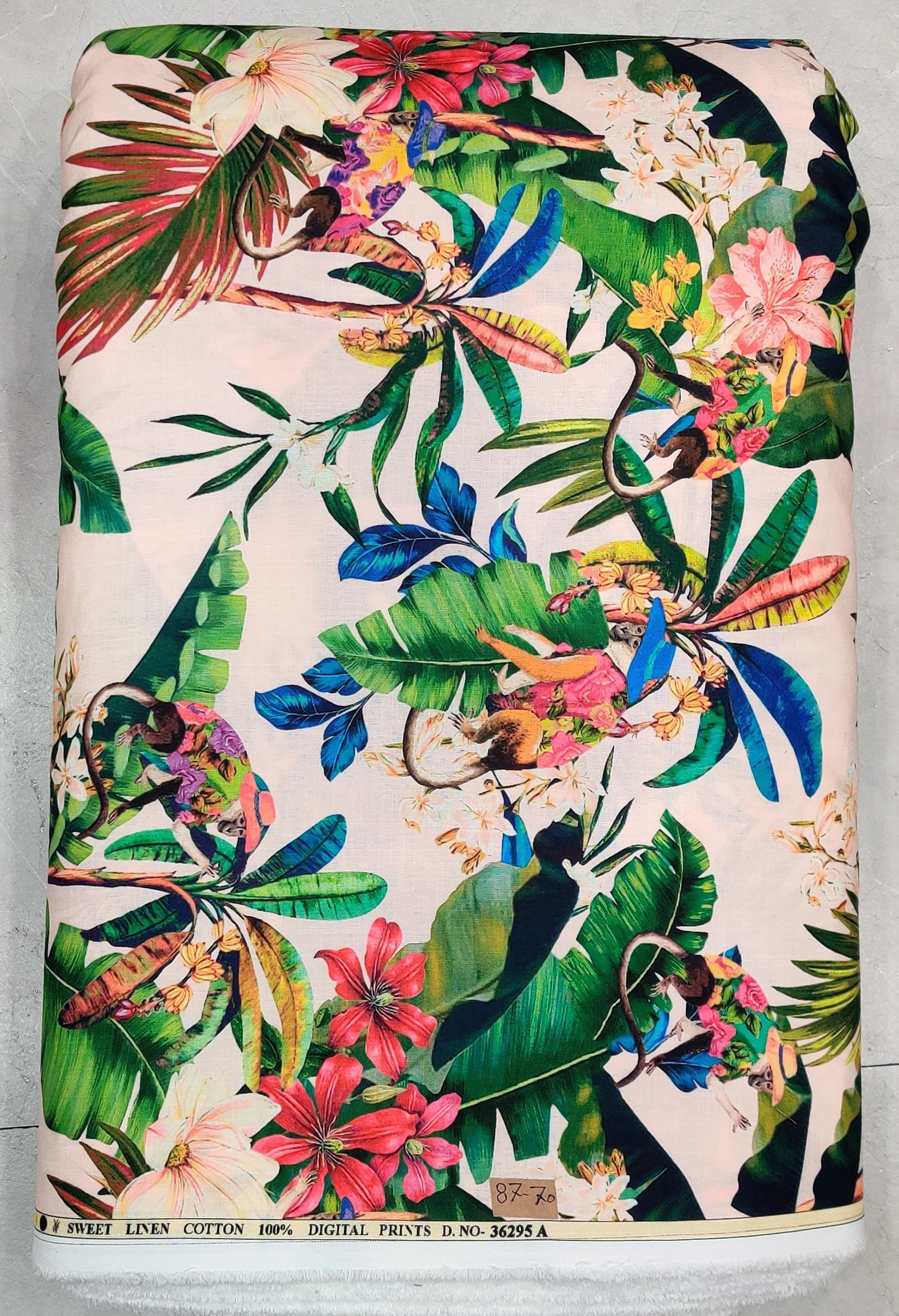 Lush ivory, vibrant turquoise, and rich coral-pink tropical fabric featuring a dense all-over botanical print with exotic palm fronds, blooming hibiscus flowers, and colorful birds.