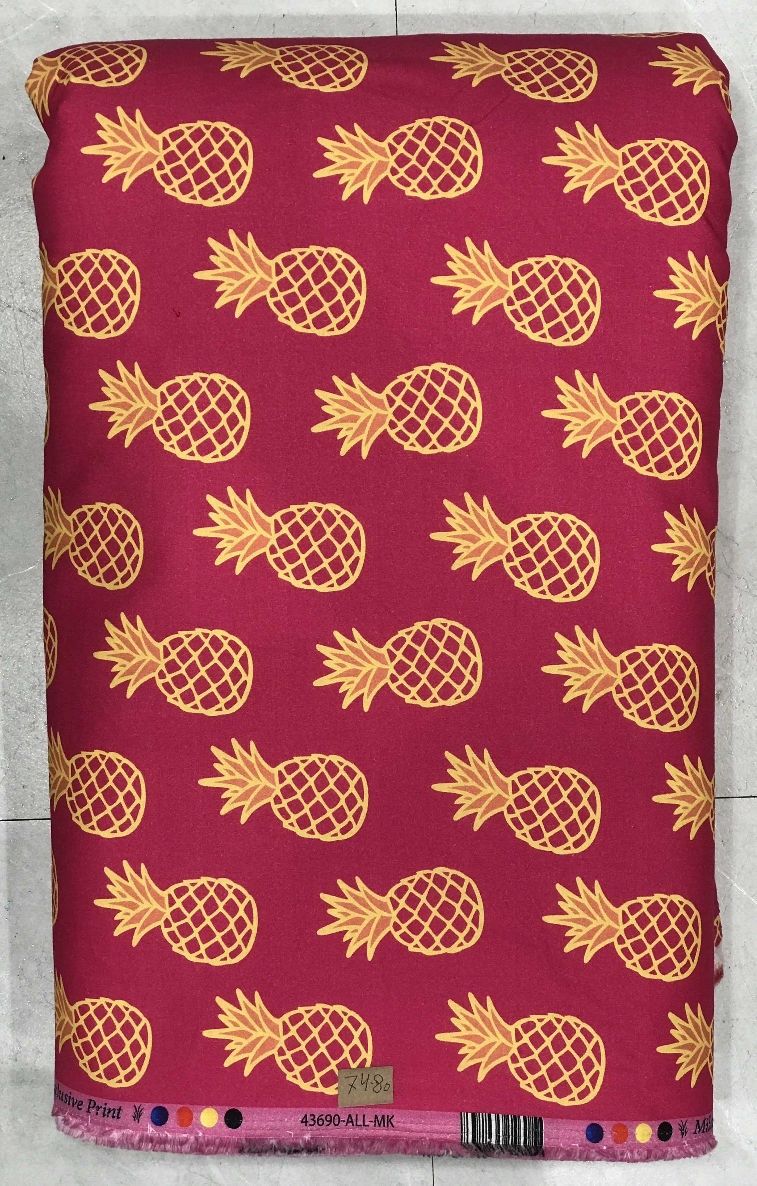 Rich deep magenta-pink or ruby background featuring a playful repeating pattern of golden-yellow pineapples with dark detailing and leafy crowns.
