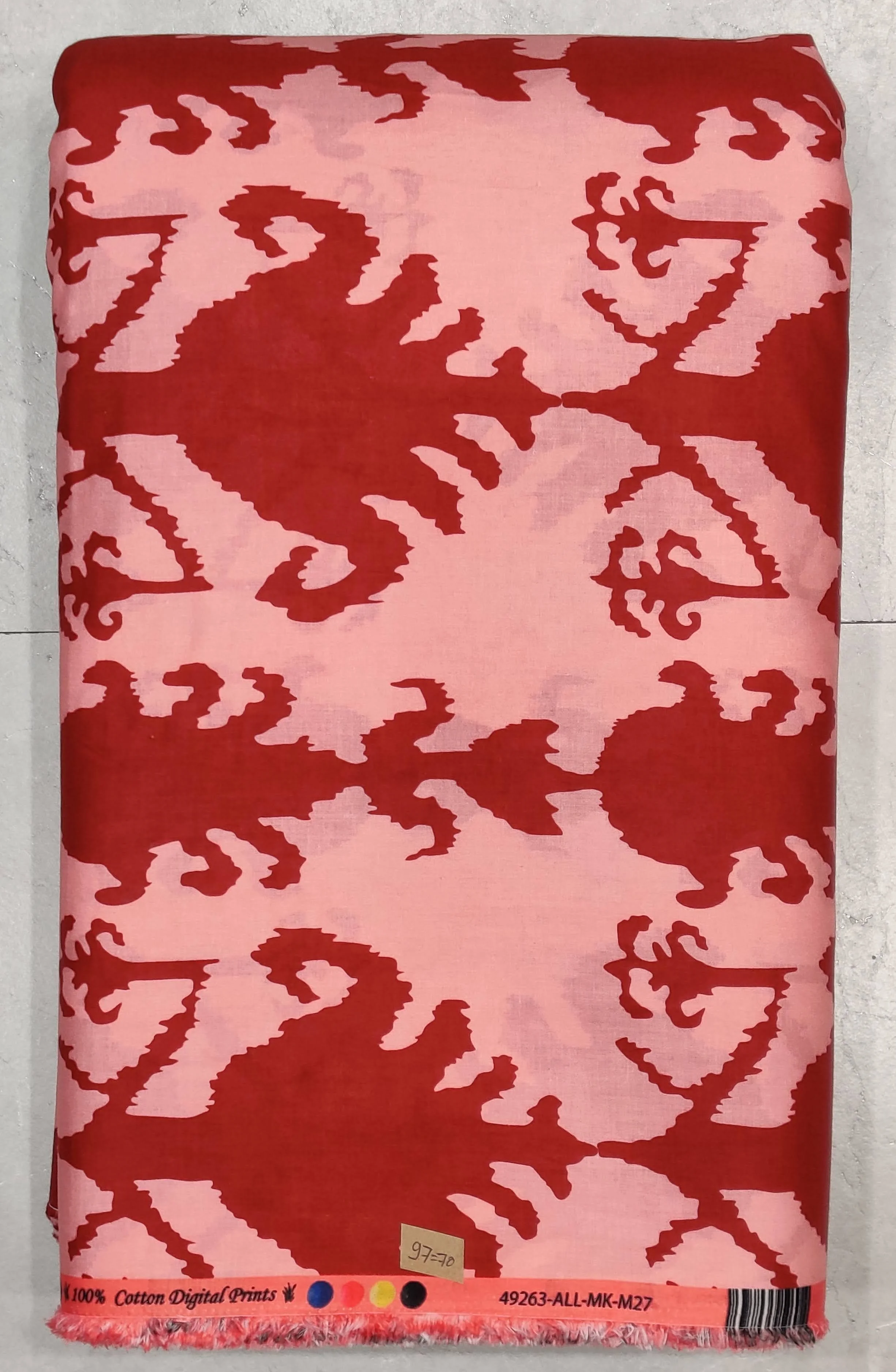 Detailed block-style printed fabric featuring quirky dark red crab and abstract geometric motifs set against a soft blush pink base.