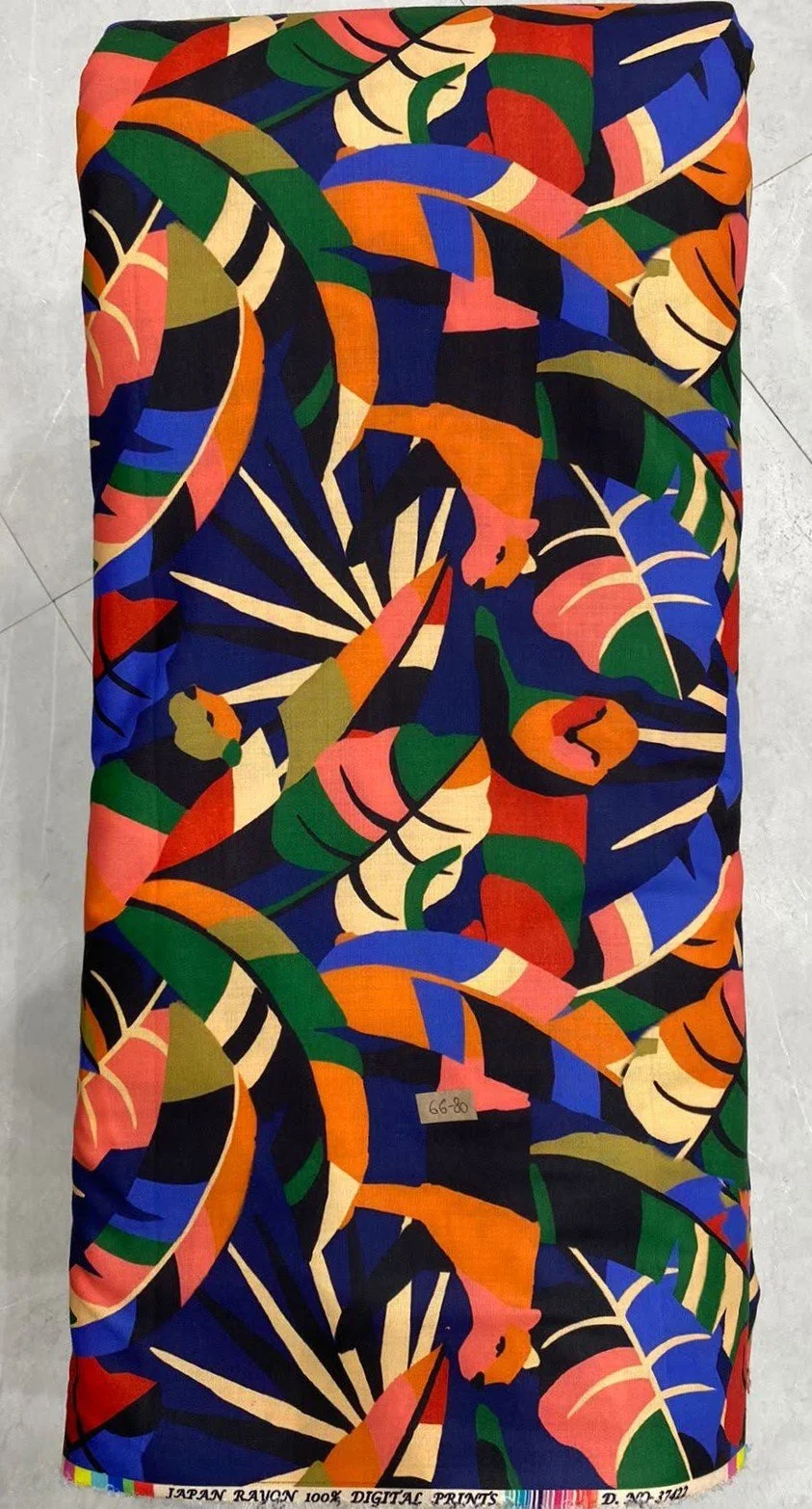 Rich multi-colored fabric featuring a dynamic abstract pattern with sweeping fluid strokes in warm coral, yellow, and deep navy-blue tones against a dark backdrop.