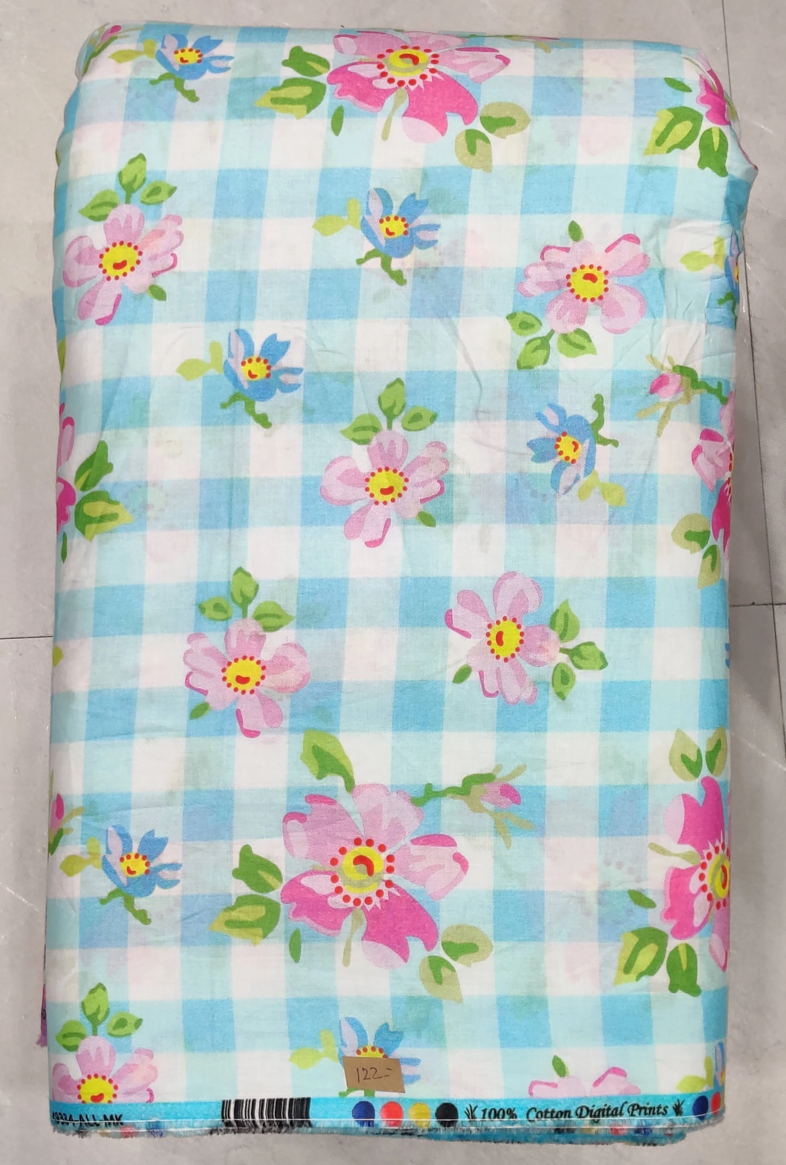 Classic light blue and white gingham check pattern adorned with scattered clusters of vintage-style pink floral bouquets and soft green leaves.