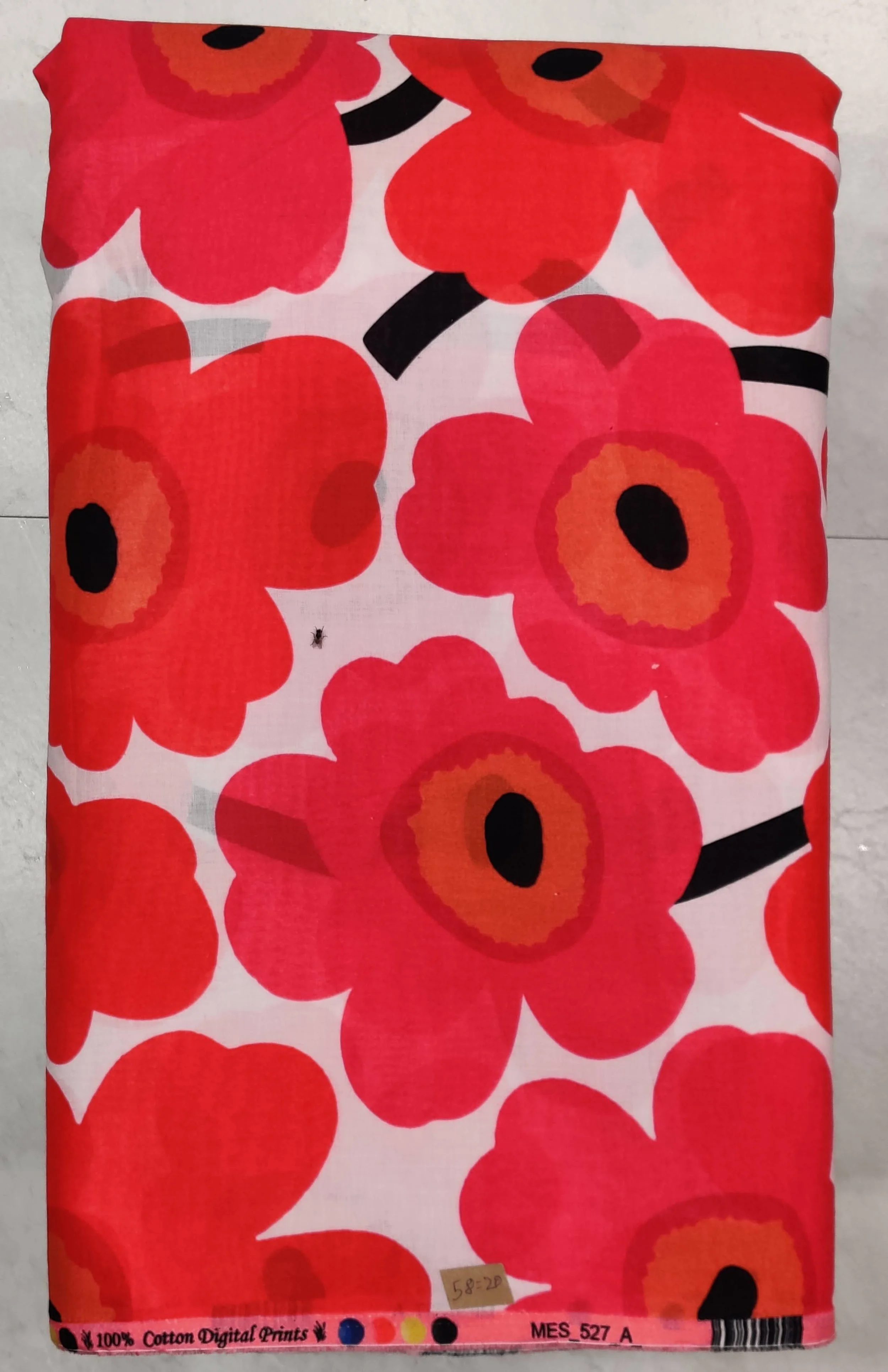 Crisp white fabric featuring a bold, retro-style floral print with large vibrant red flowers and black accents.