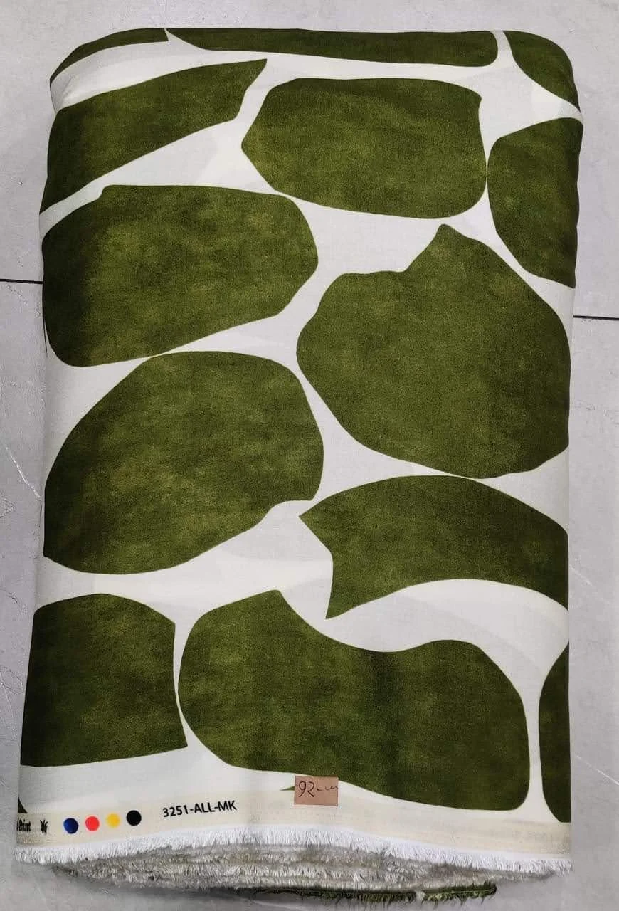 Rich golden-amber and deep olive-green fabric featuring a large-scale abstract botanical composition with sweeping curved leaves, fluid organic shapes, and a smooth dual-tone contrast.
