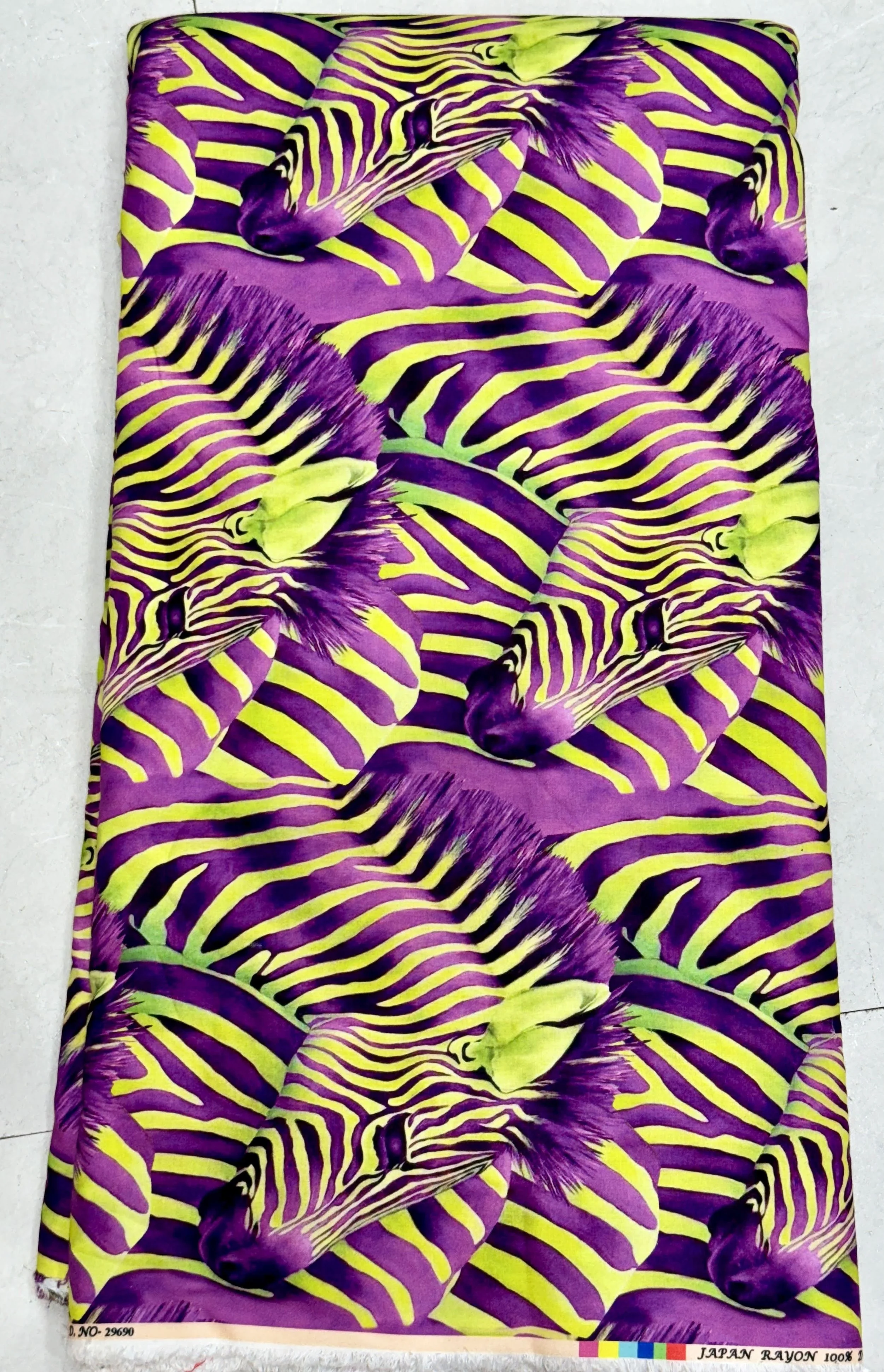 Vibrant purple and yellow fabric featuring an abstract, flowing tiger-stripe pattern with dynamic zebra-like waves.