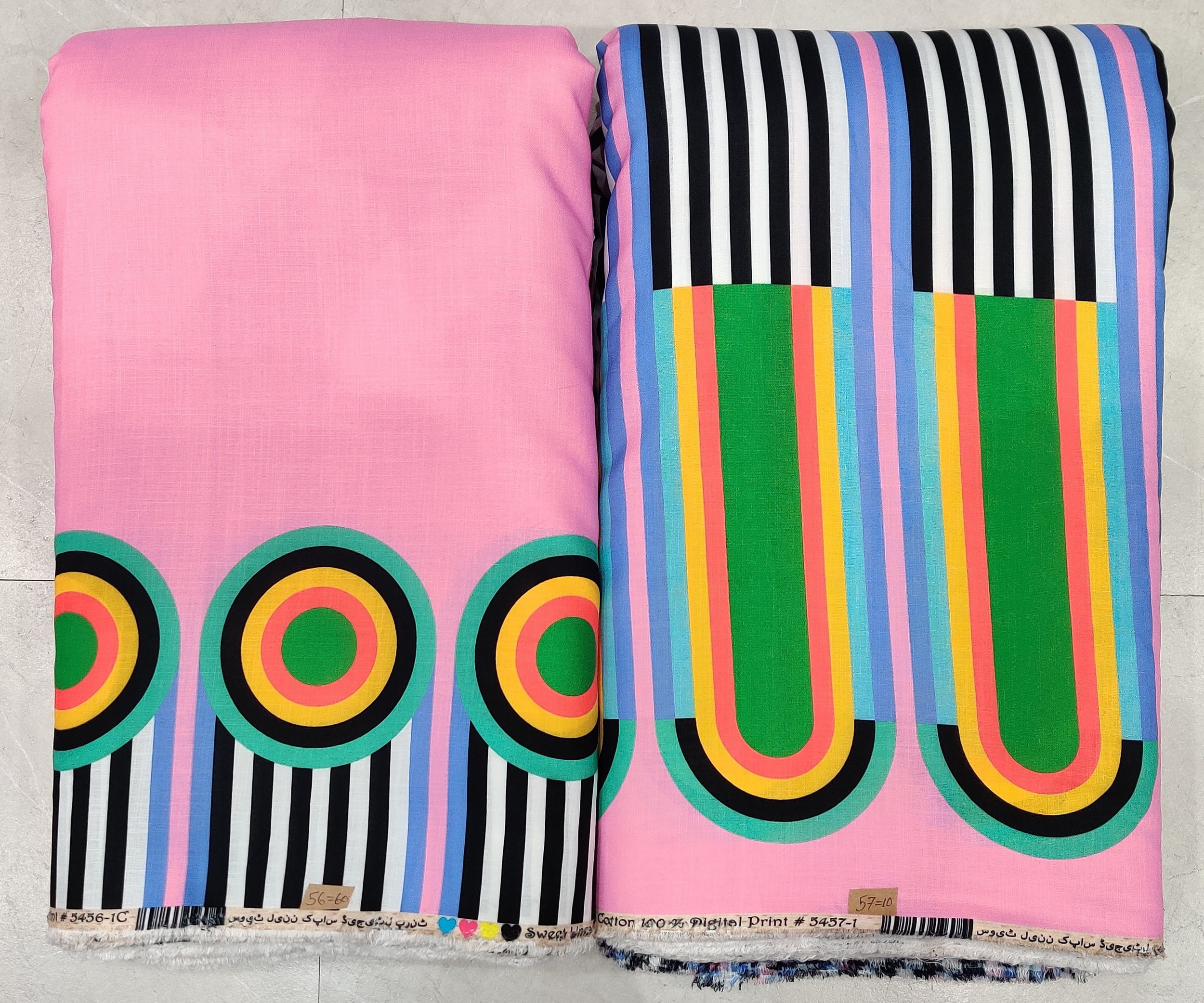 Chic bubblegum-pink and turquoise modal-cotton fabric featuring a bold modern art print with striking circular neon-framed motifs, paired with vertical striped paneling and a unique artistic hemline.