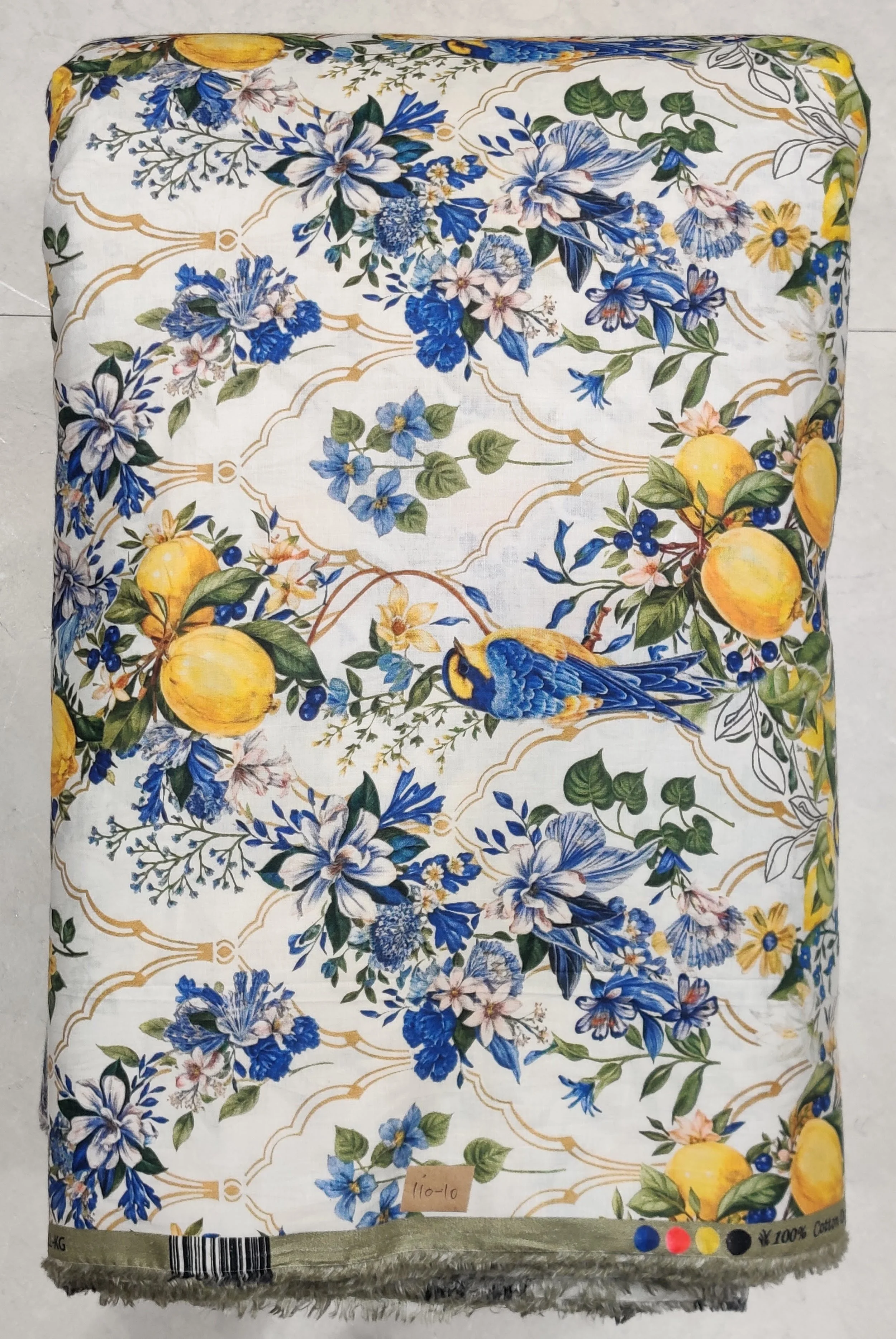 White background featuring a trailing blue floral vine pattern accented with bright yellow lemons.