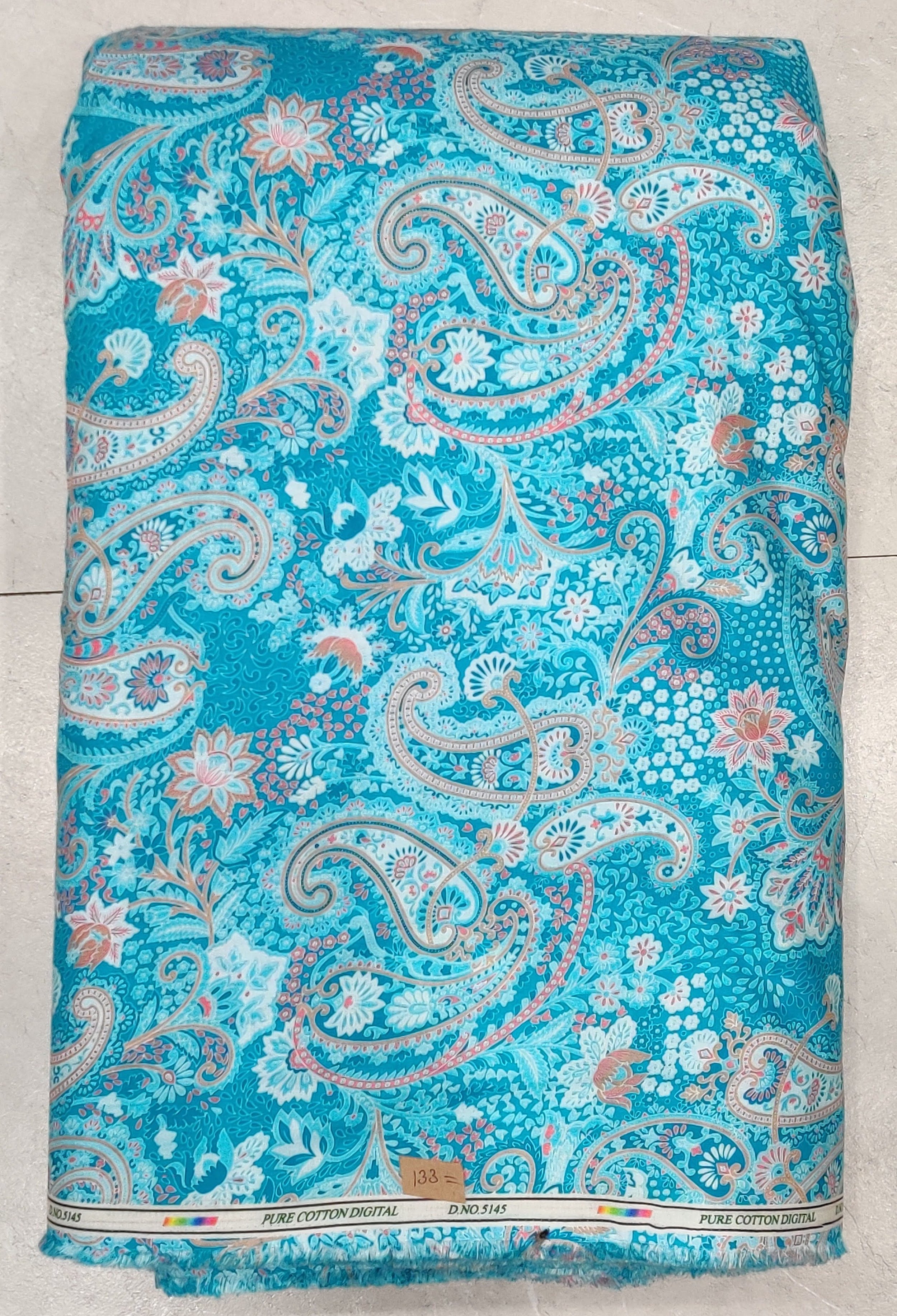 Bright turquoise base featuring large traditional paisley motifs and small pink and white floral accents.