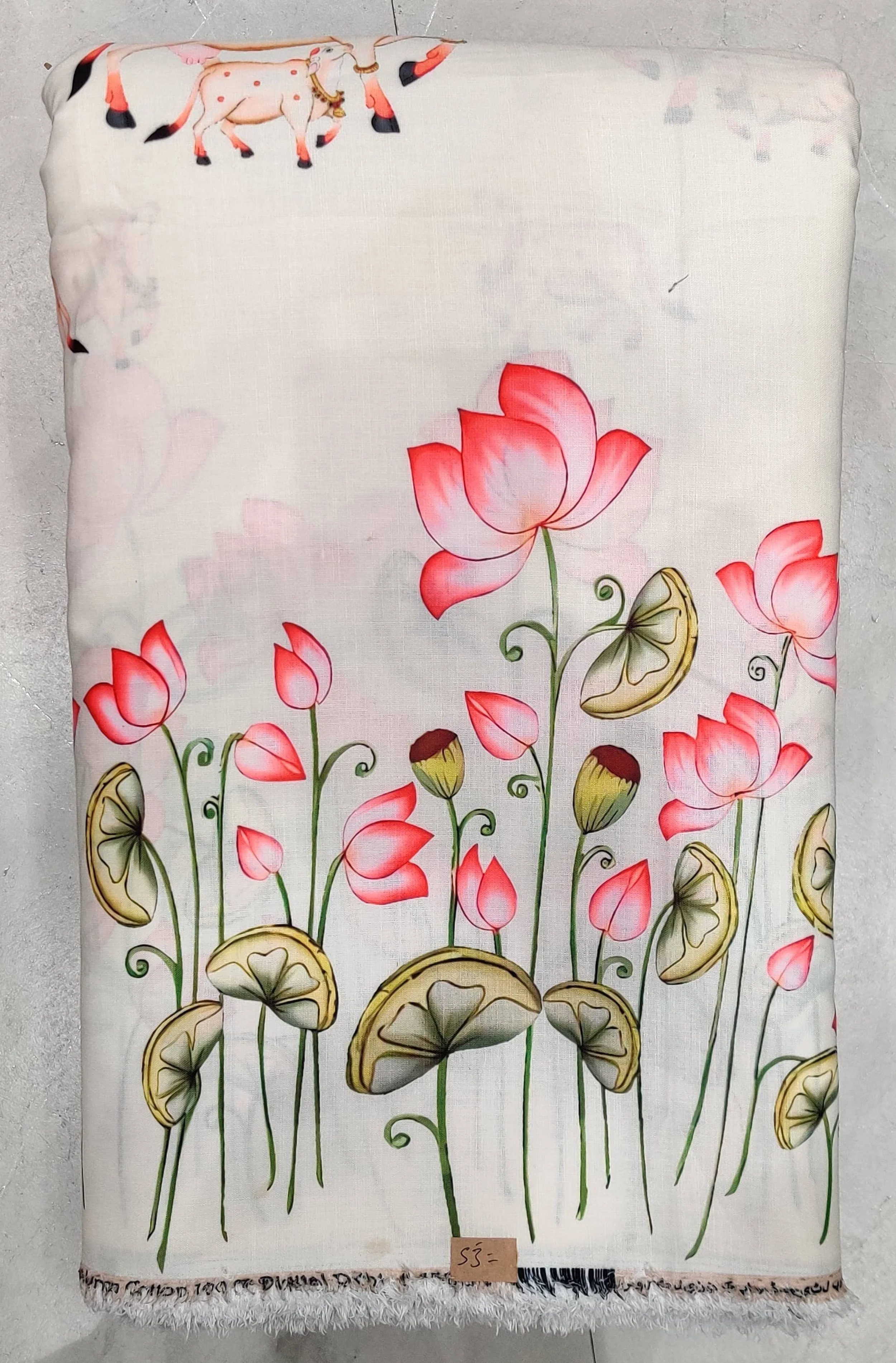 Lush ivory-white and pastel-pink fabric featuring delicate blooming lotus flowers and floating lily pads along a serene aquatic border composition.