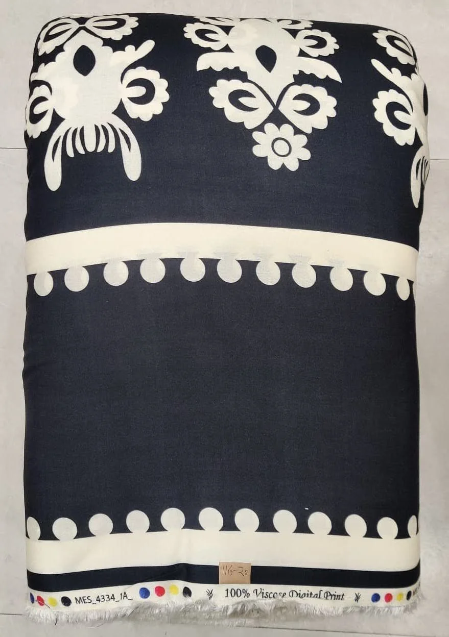 Deep midnight-black and crisp ivory textile showcasing a bold geometric motif featuring structured tribal symbols, rhythmic zigzag bands, and sharp linear alignments.