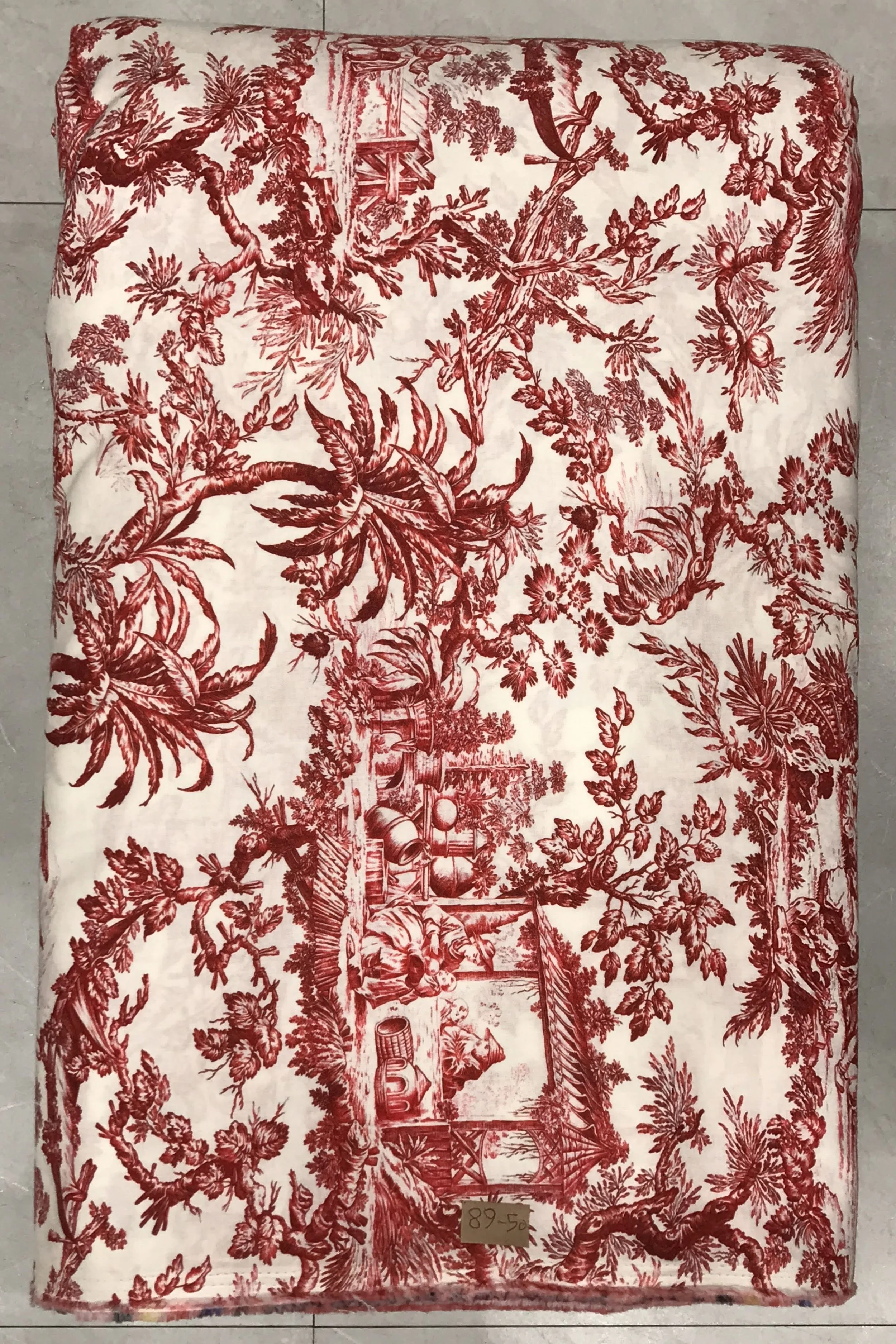 Rich cream and burgundy background featuring a classic Toile de Jouy print depicting detailed pastoral scenes, rustic structures, and lush foliage in a traditional French country style.