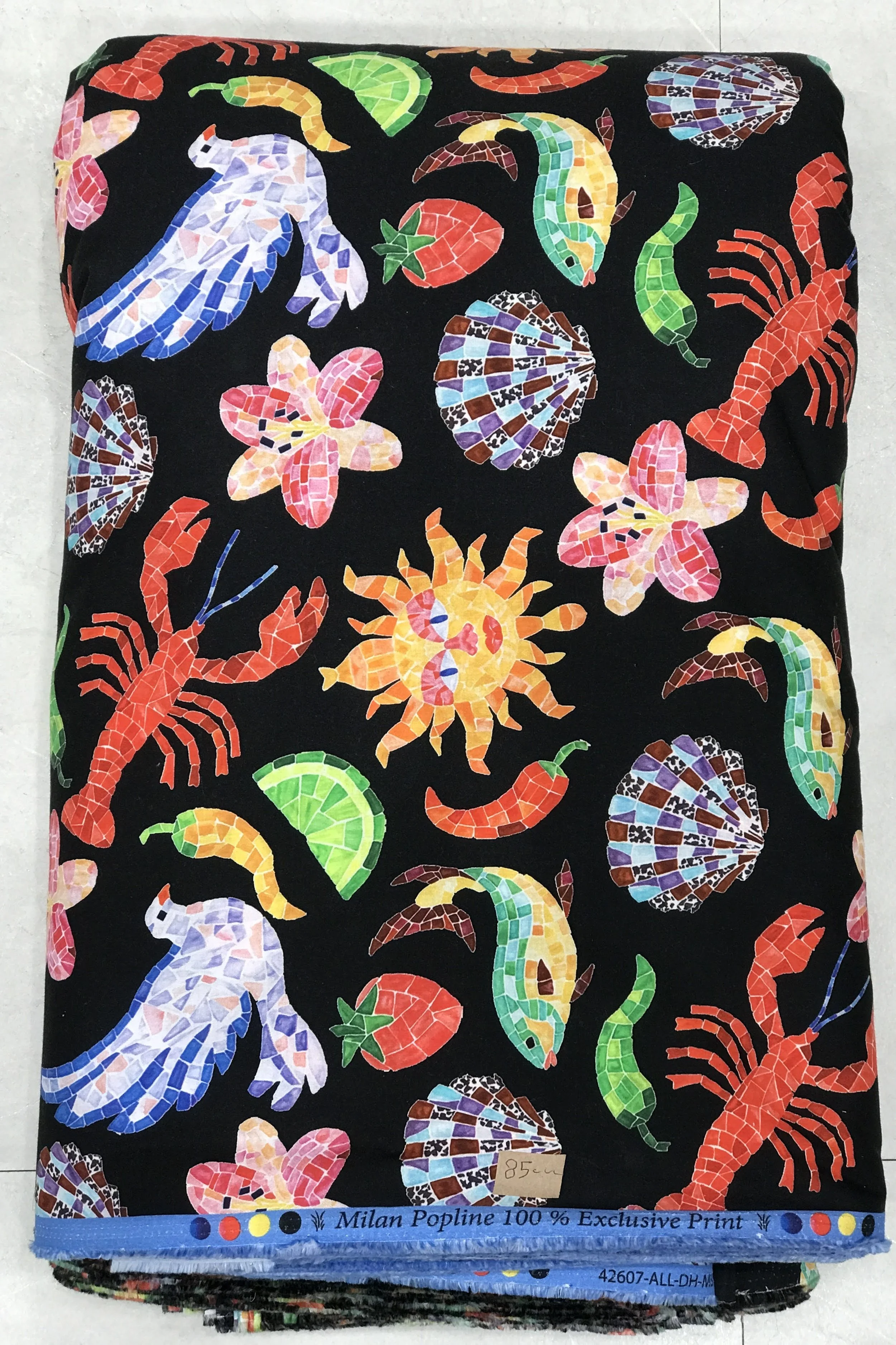 Rich black background featuring a playful and eclectic marine-inspired print with colorful lobsters, glowing sun motifs, starfish, seashells, and whimsical sea elements.
