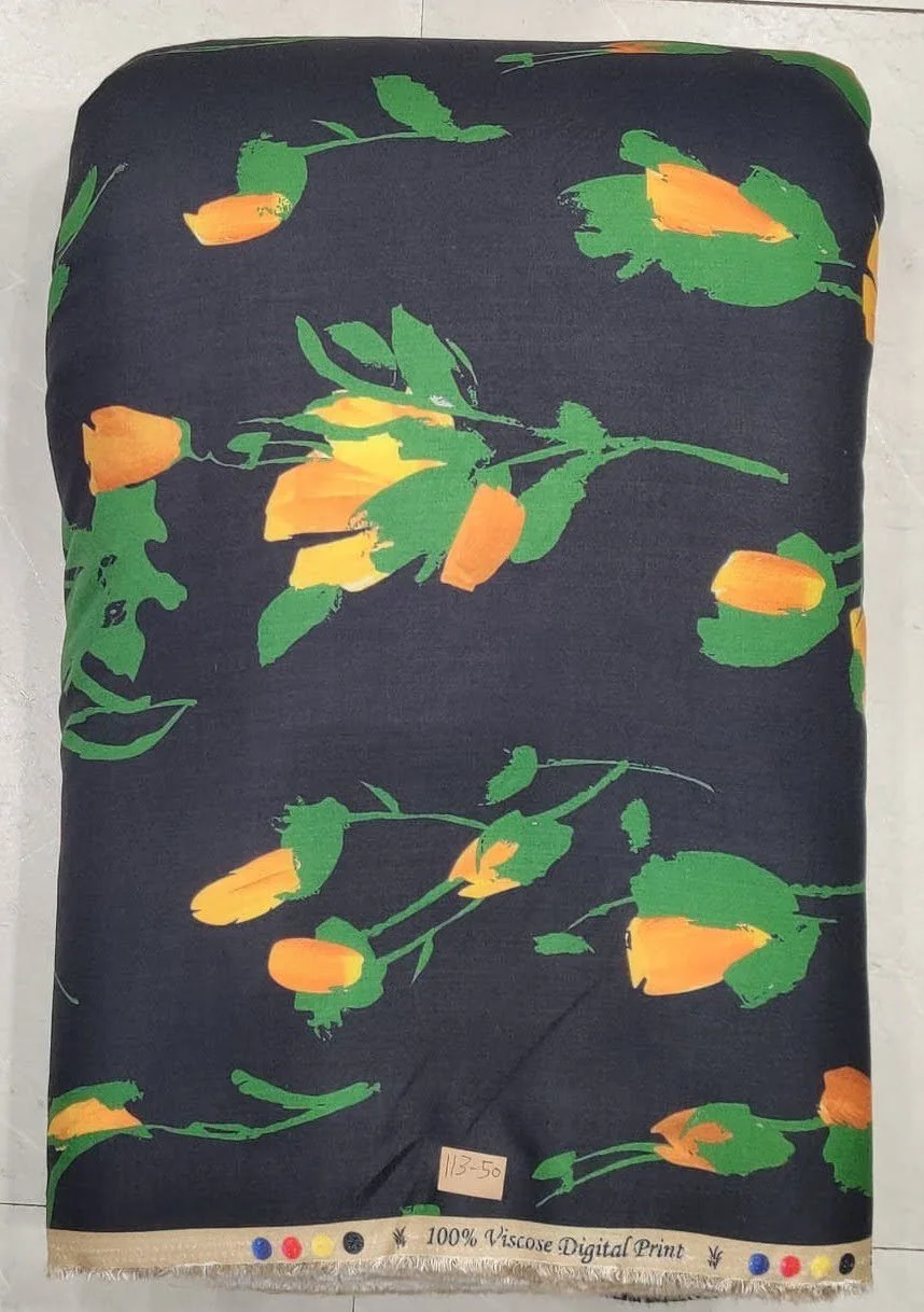Deep midnight-black and marigold-yellow fabric highlighting an expressive botanical composition featuring slender blooming flowers, graceful curving stems, and smooth flowing foliage accents.