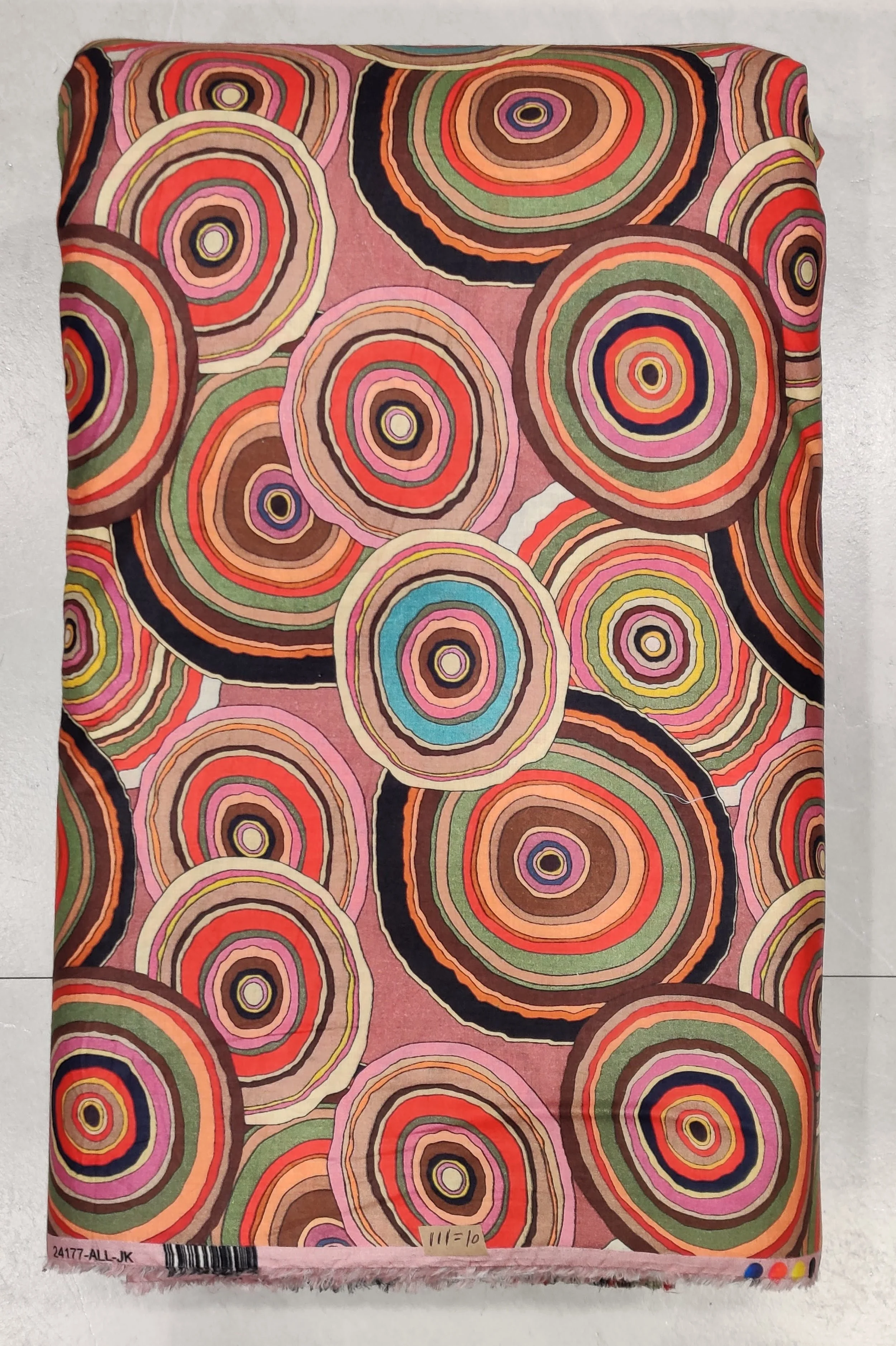 Warm pink and rust concentric circle print, ideal for crafting retro-chic tunics and contemporary statement dresses.
