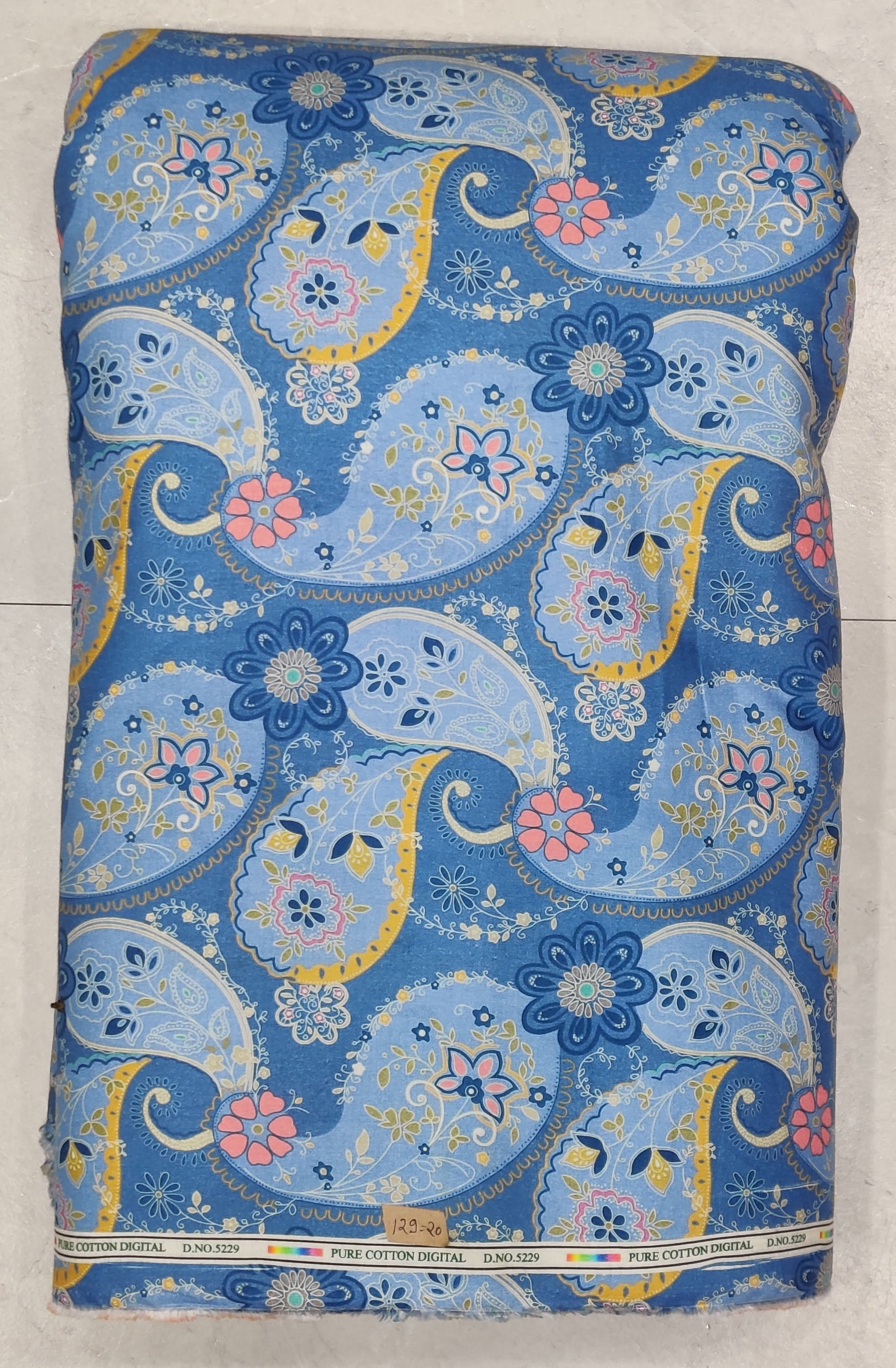 Blue base featuring large, traditional paisley motifs with intricate yellow, red, and white detailing.