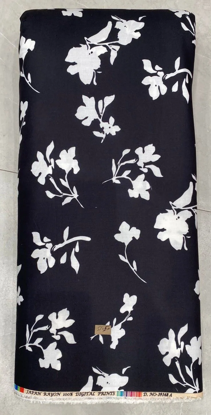 Deep navy-blue fabric featuring a dense floral pattern with prominent white and cream blossoms, subtle yellow centers, and detailed green foliage.