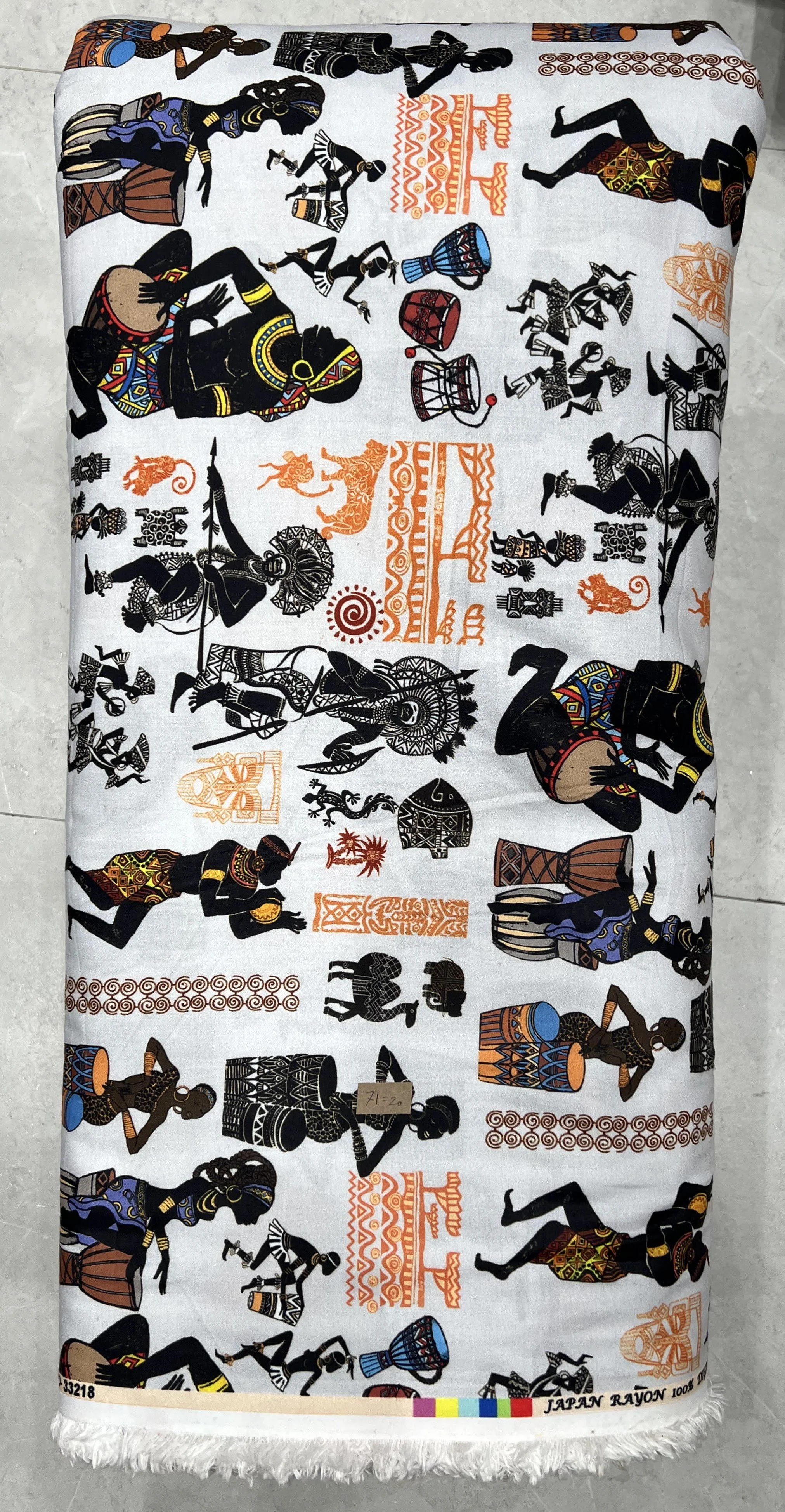 Crisp white fabric featuring an all-over traditional motif pattern with intricate black and golden-yellow Japanese-style figures and ornamental designs.