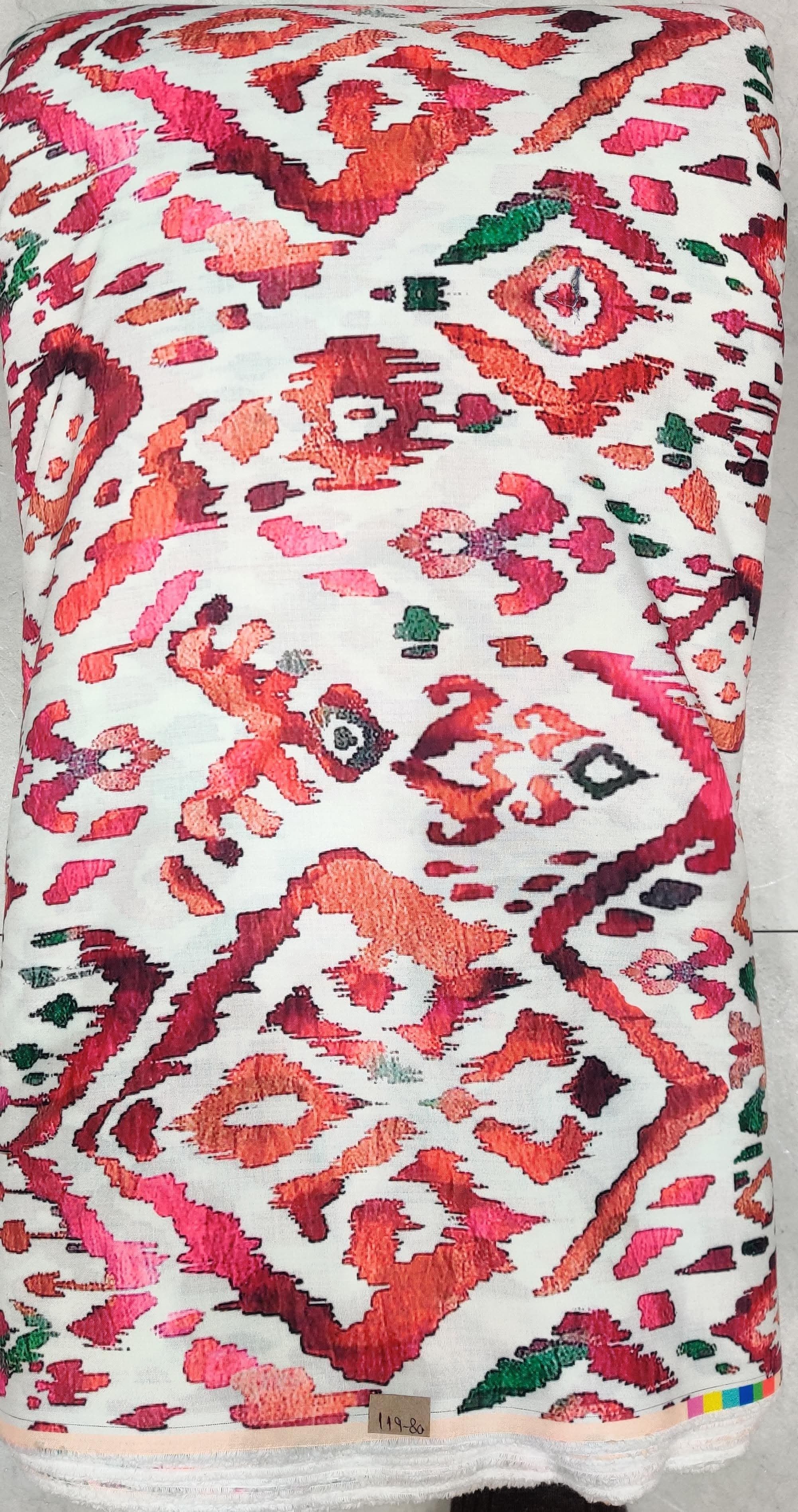 Rich white fabric featuring an intricate, ornate geometric medallion and damask-style pattern in striking shades of red and pink.