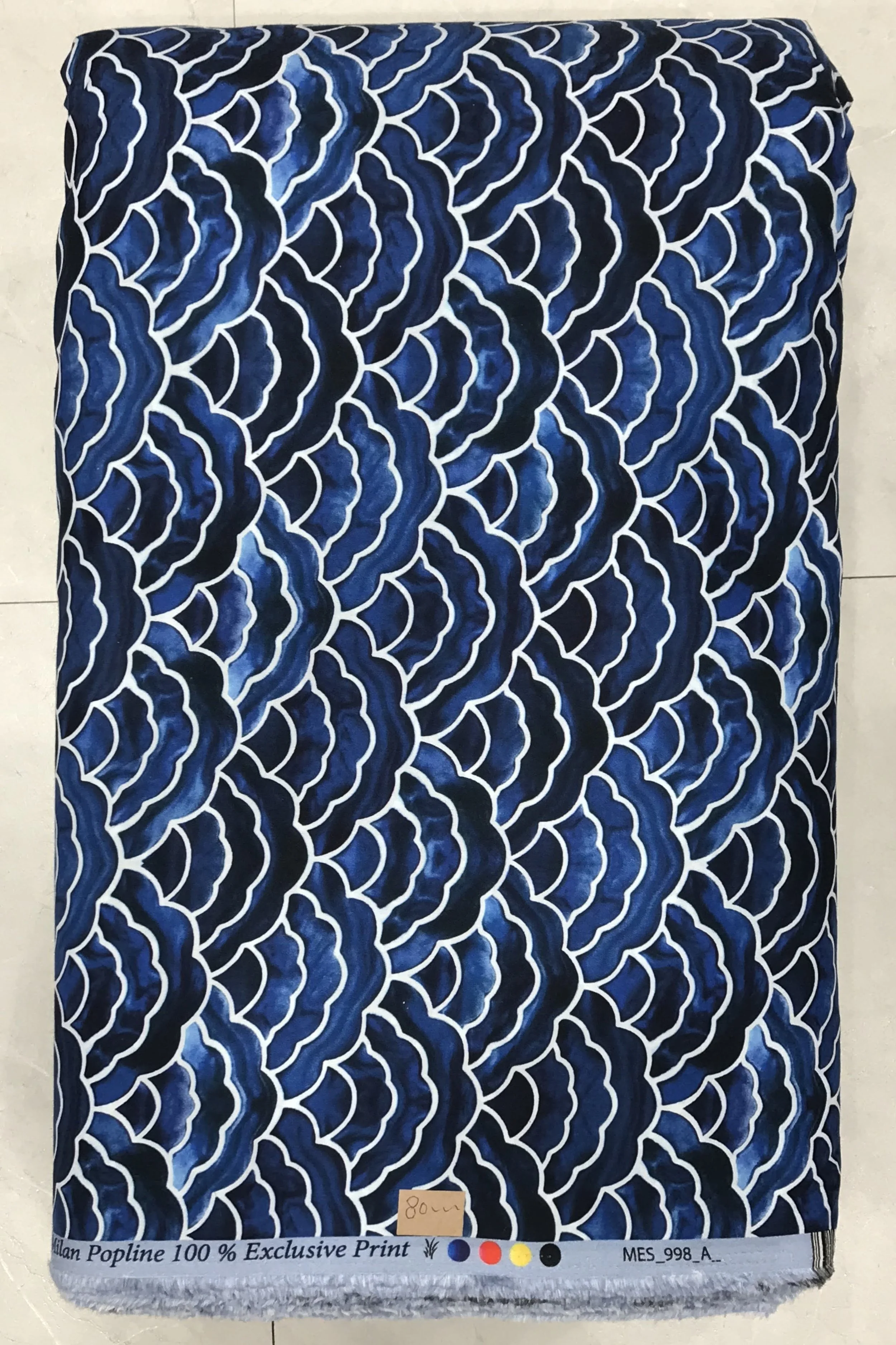 Rich royal blue background featuring a dense, dynamic abstract wave-like or scale pattern with organic flowing lines in contrasting shades of light blue, white, and subtle dark detailing.