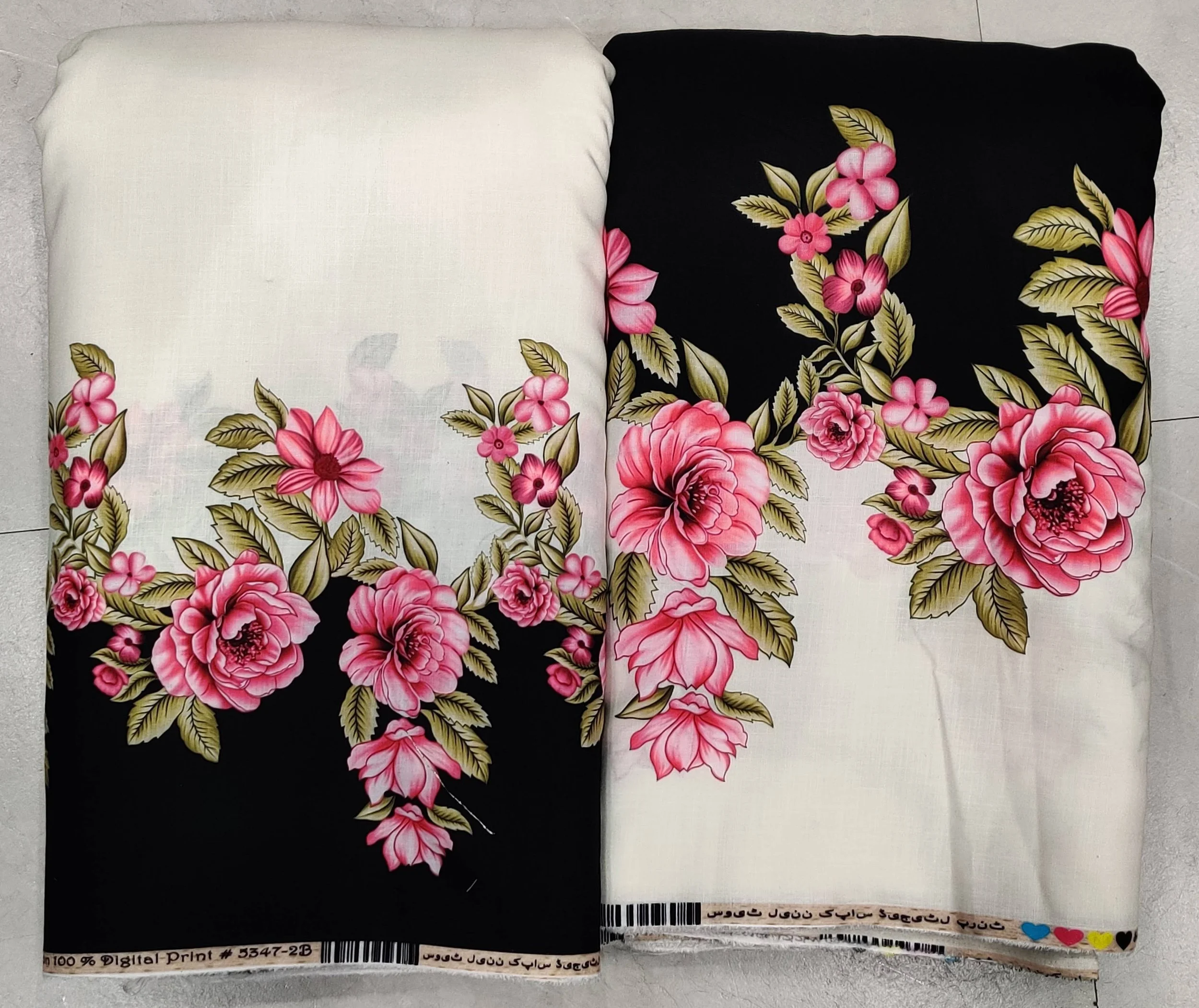 Handcrafted monochrome modal-cotton fabric showcasing an exquisite traditional floral block-print pattern on the left side, gracefully balanced by a solid jet-black right panel and an intricate geometric printed border.