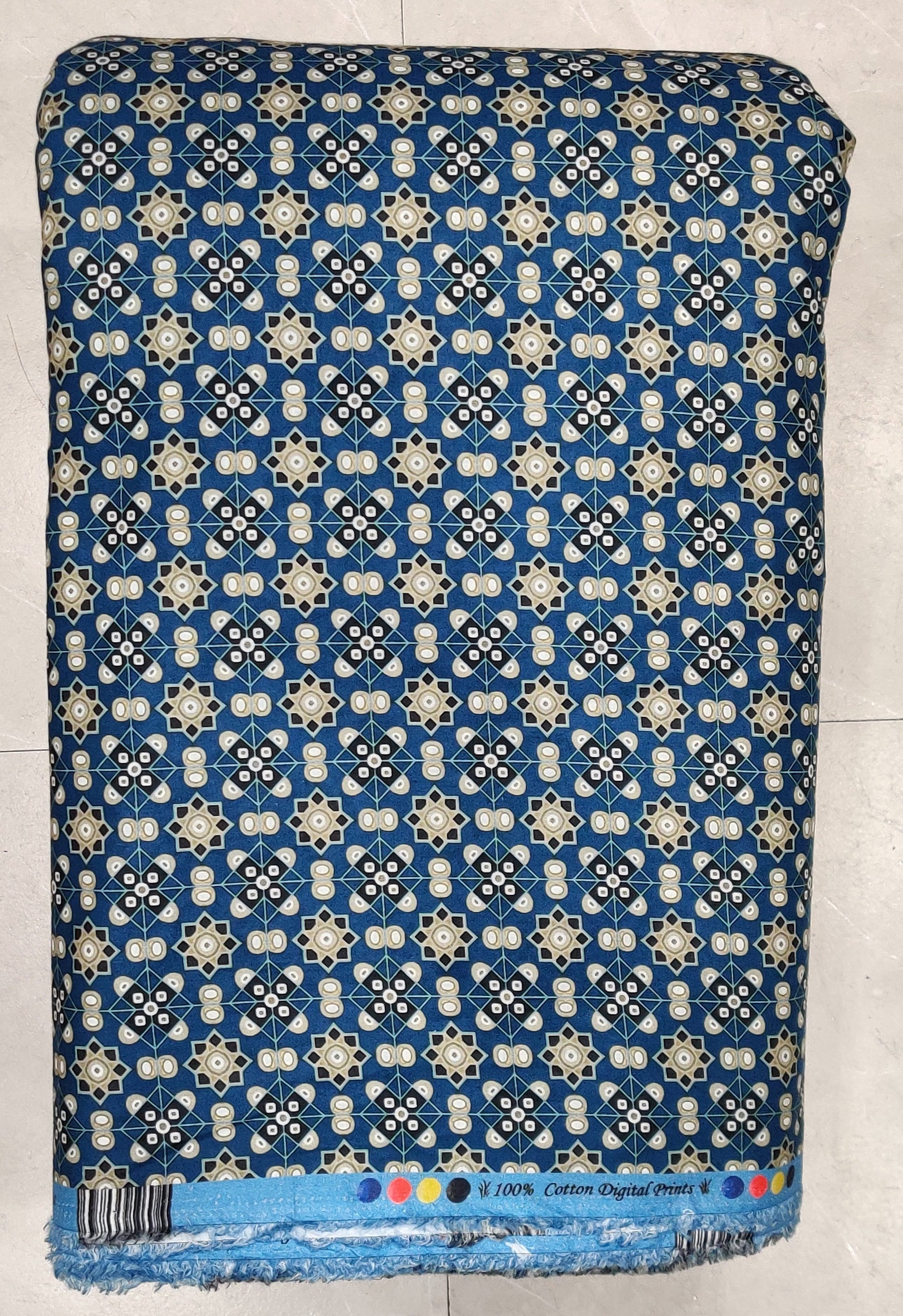 Vibrant royal blue background featuring a dense, intricate pattern of ornate gold and white motifs with delicate floral accents.