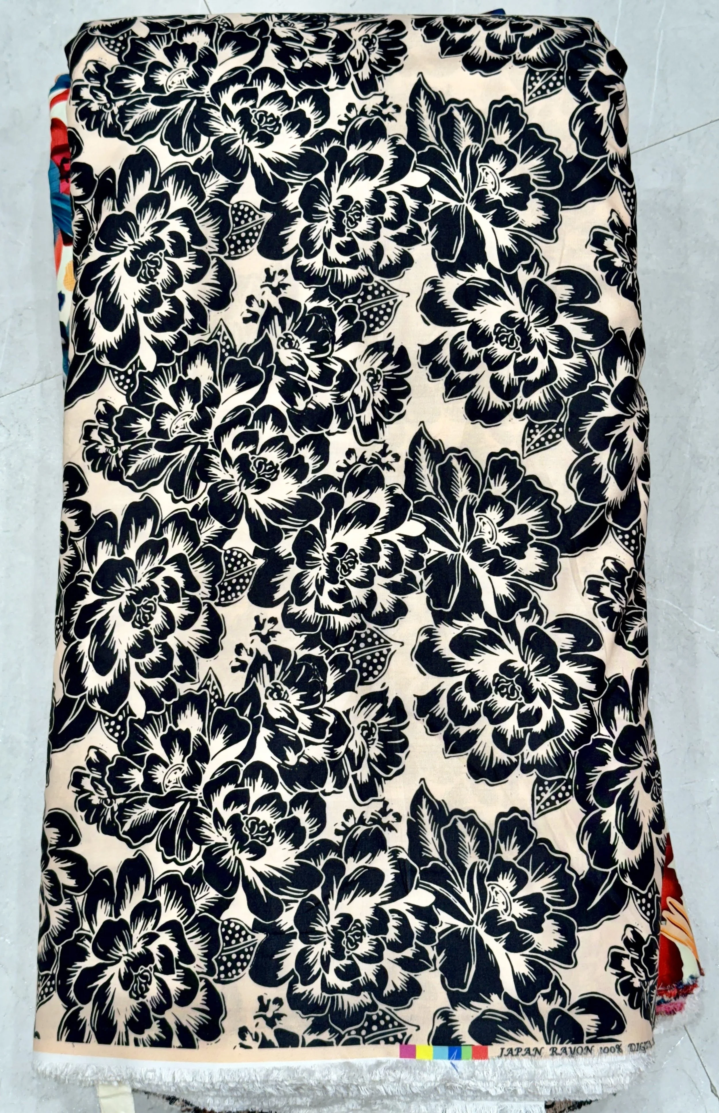 Deep navy-blue fabric featuring a dense floral pattern with prominent white and cream blossoms, subtle yellow centers, and detailed green foliage.