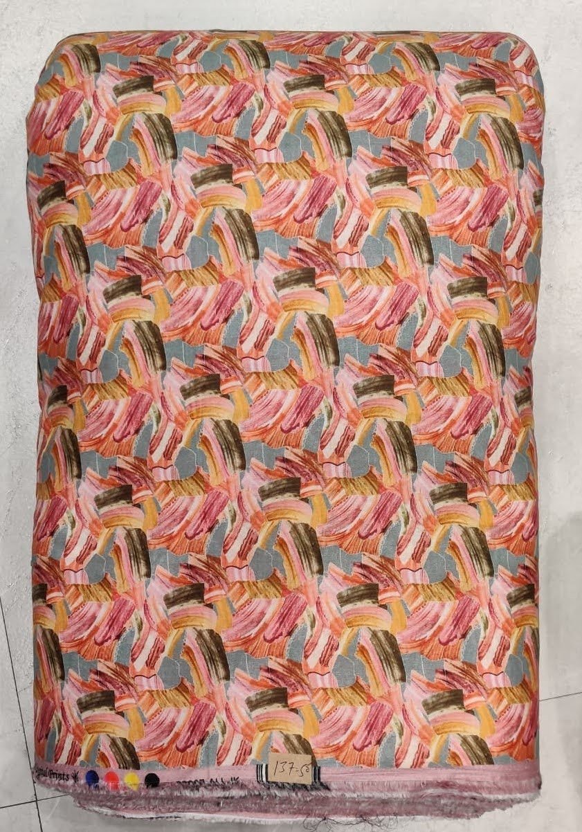 Rich black background covered in a dense, colorful medley of small-scale paisley and floral prints in vibrant shades of pink, yellow, blue, and green.