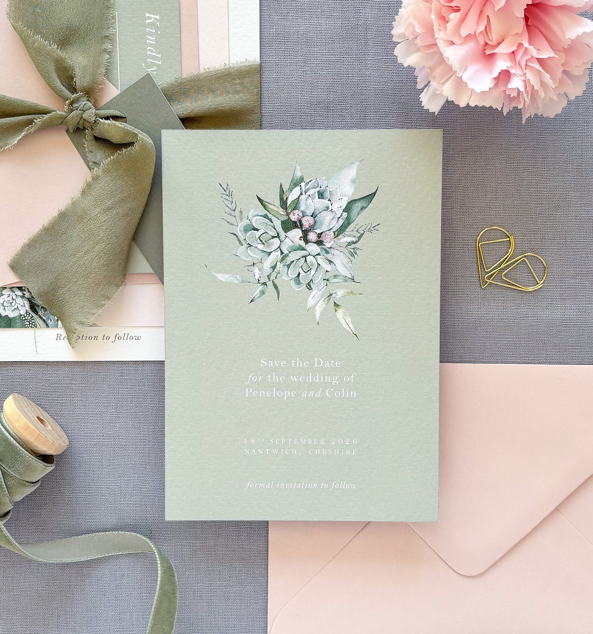 Personalised 'Save the Date' card in sage green, designed by The Paper and Ribbon Co., with delicate botanical design and contemporary style.