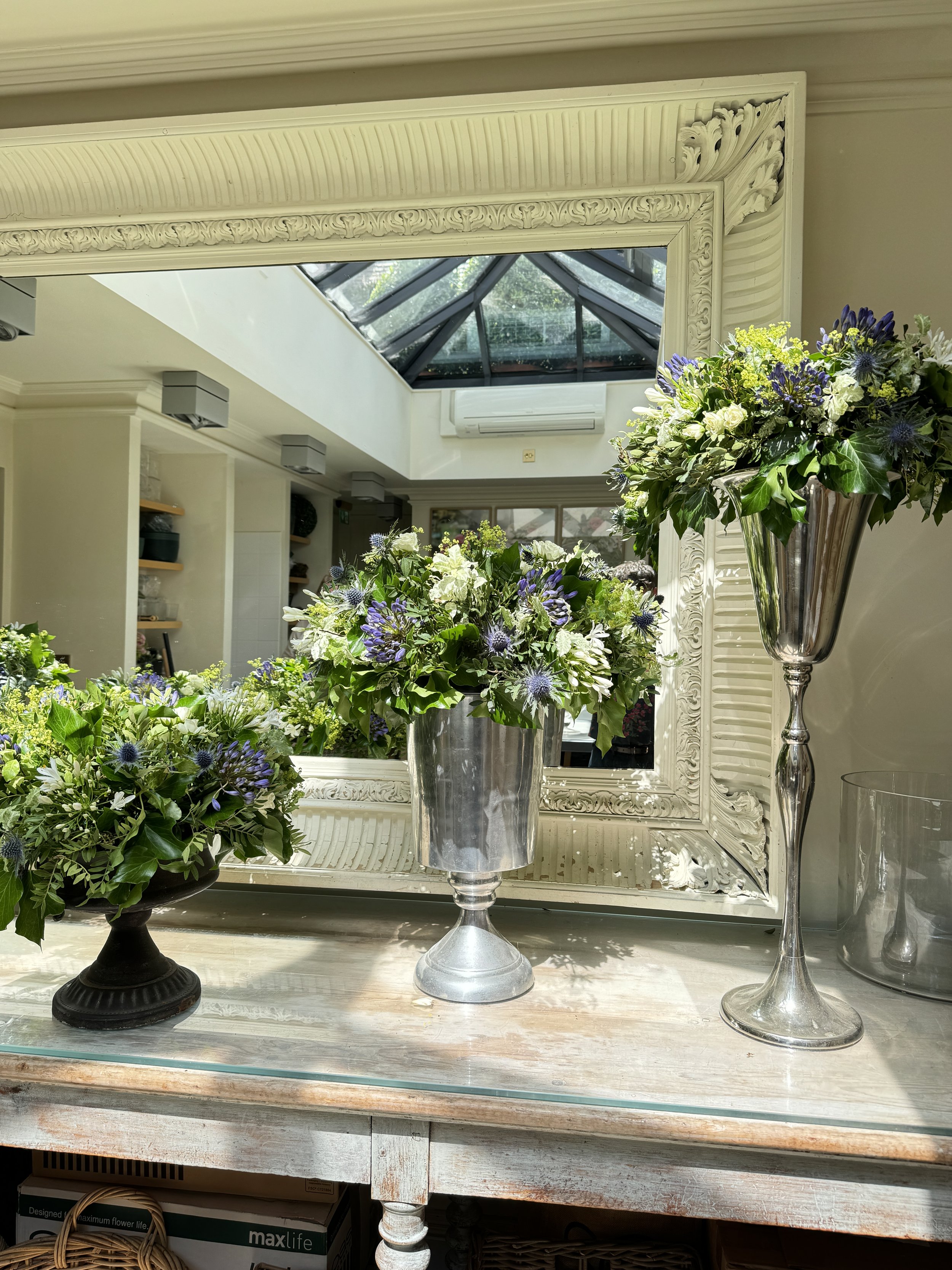 Three different vases with luxury flower arrangements created by Stockholm wedding florist John Young Florals