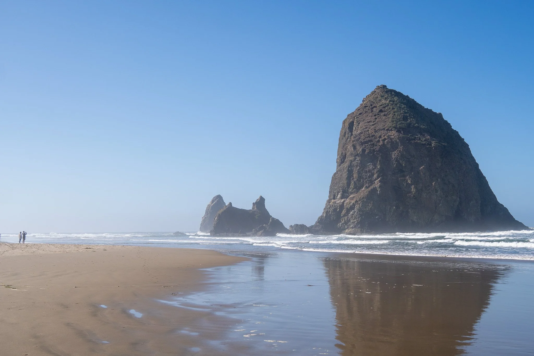 people looking at rock on beach, cannon beach, oregon, usa.jpg