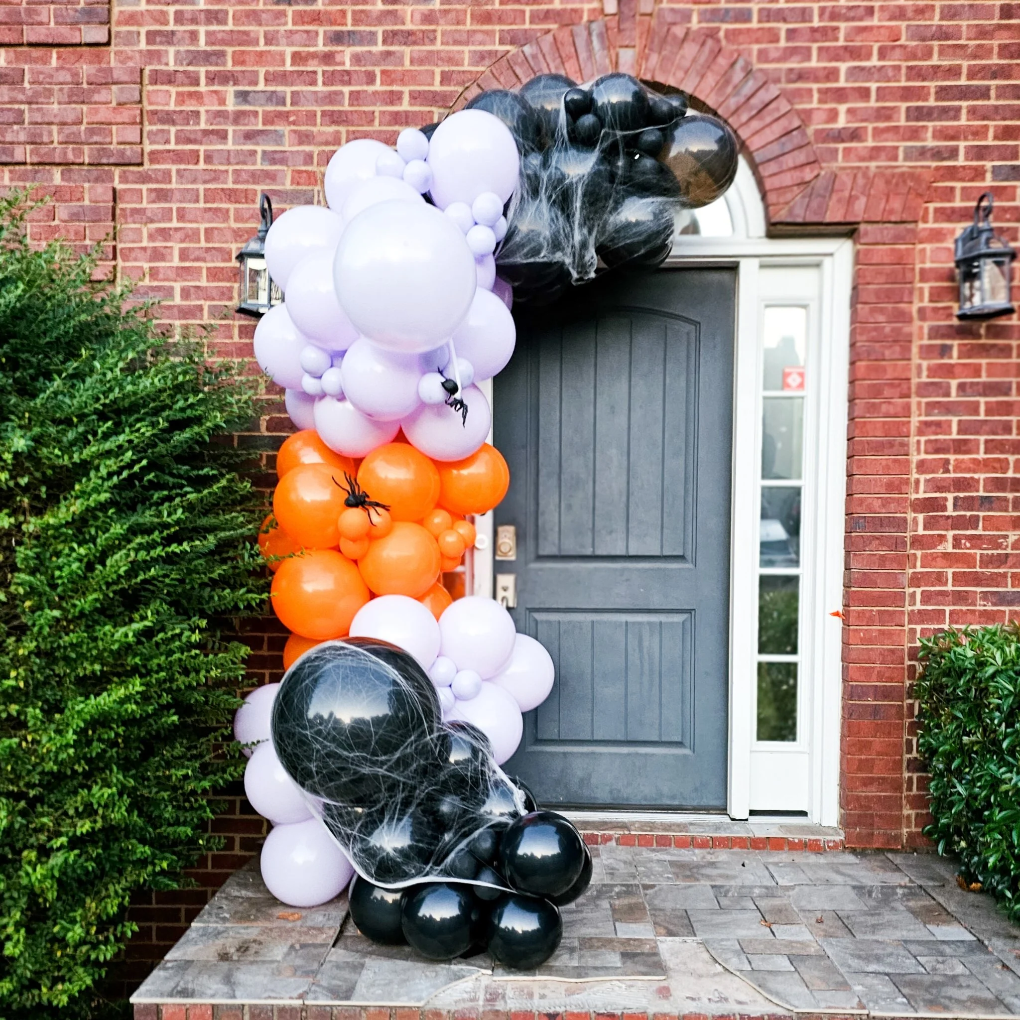 purple orange and black Halloween themed balloon garland in Atlanta with cobwebs and spiders