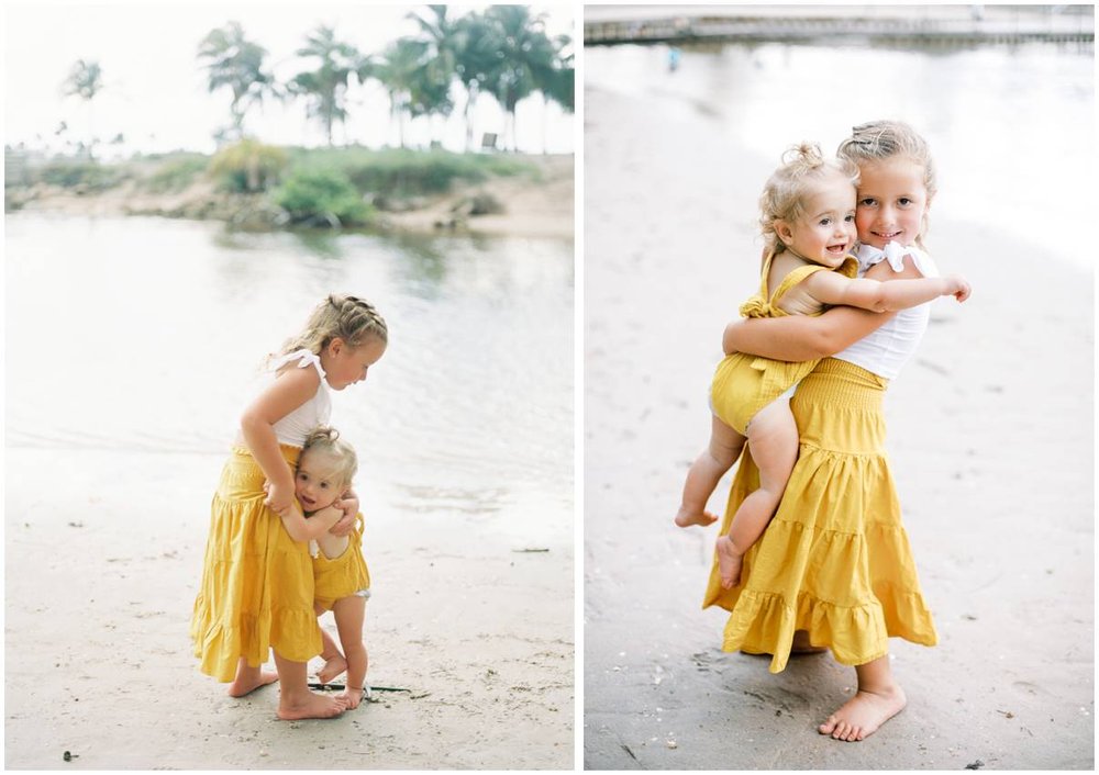sisters hug eachother at their family session in jupiter
