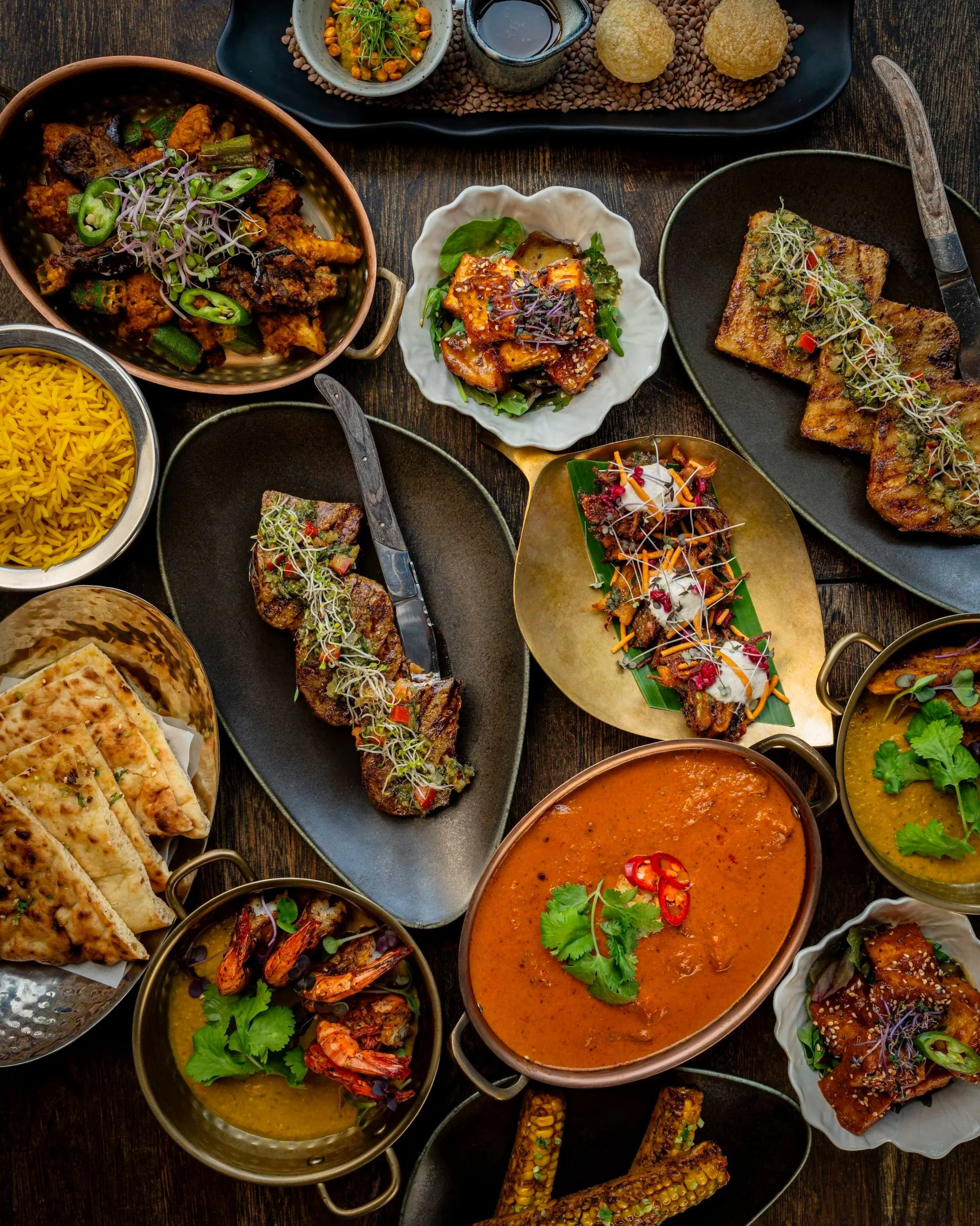 Zahida Copenhagen tasting spread with maasla striploin, curry bowls, and rice and naan