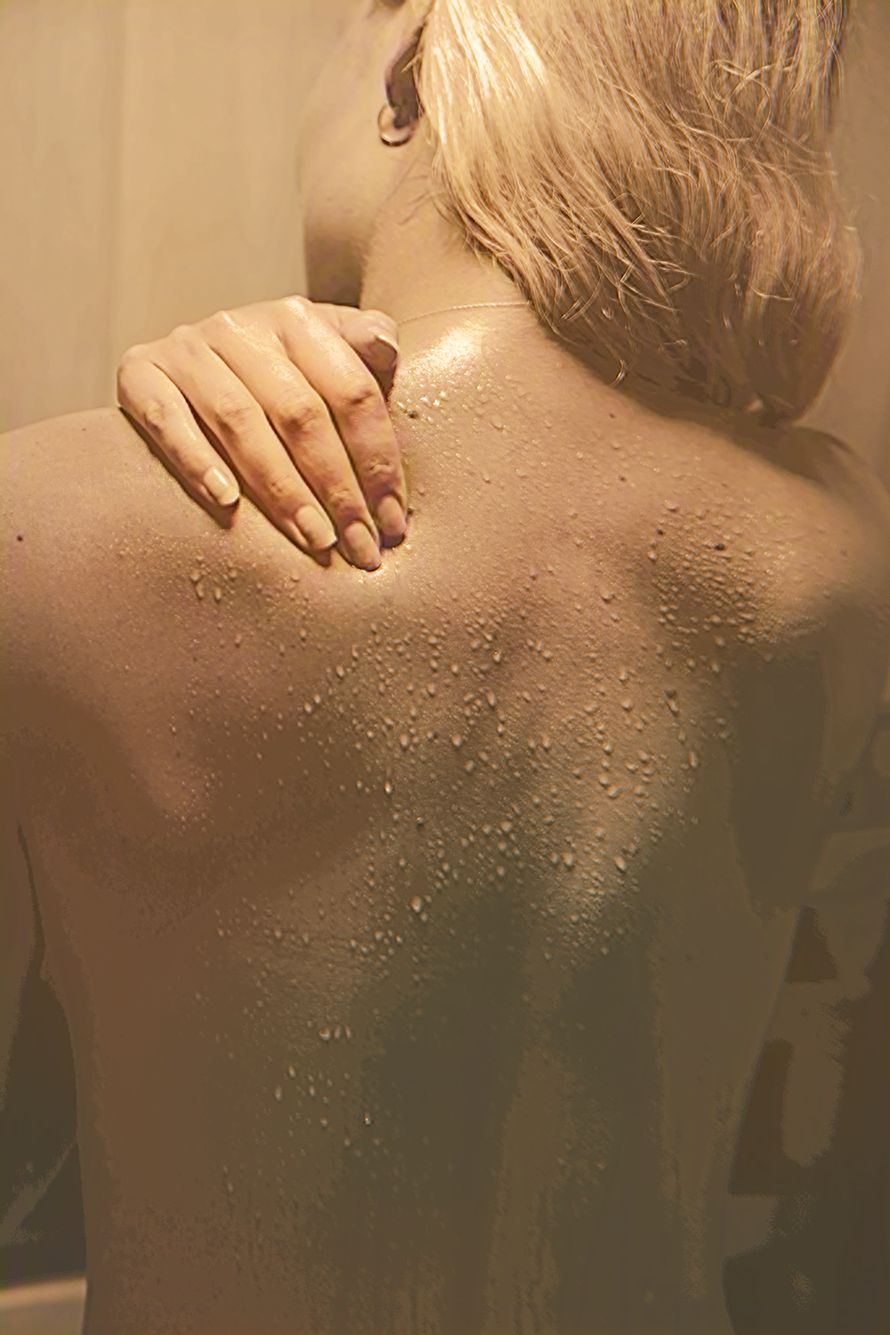 Person relaxing in a sauna with warm steam on their skin, highlighting the health benefits of regular sauna.