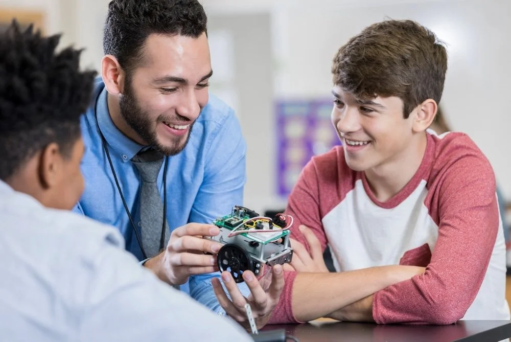 Teacher with two students delivering a STEM-focused lesson and high-quality learning