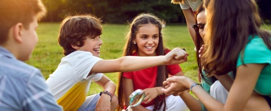 Engaged group of school students outside learning about Australian culture, Country and belonging