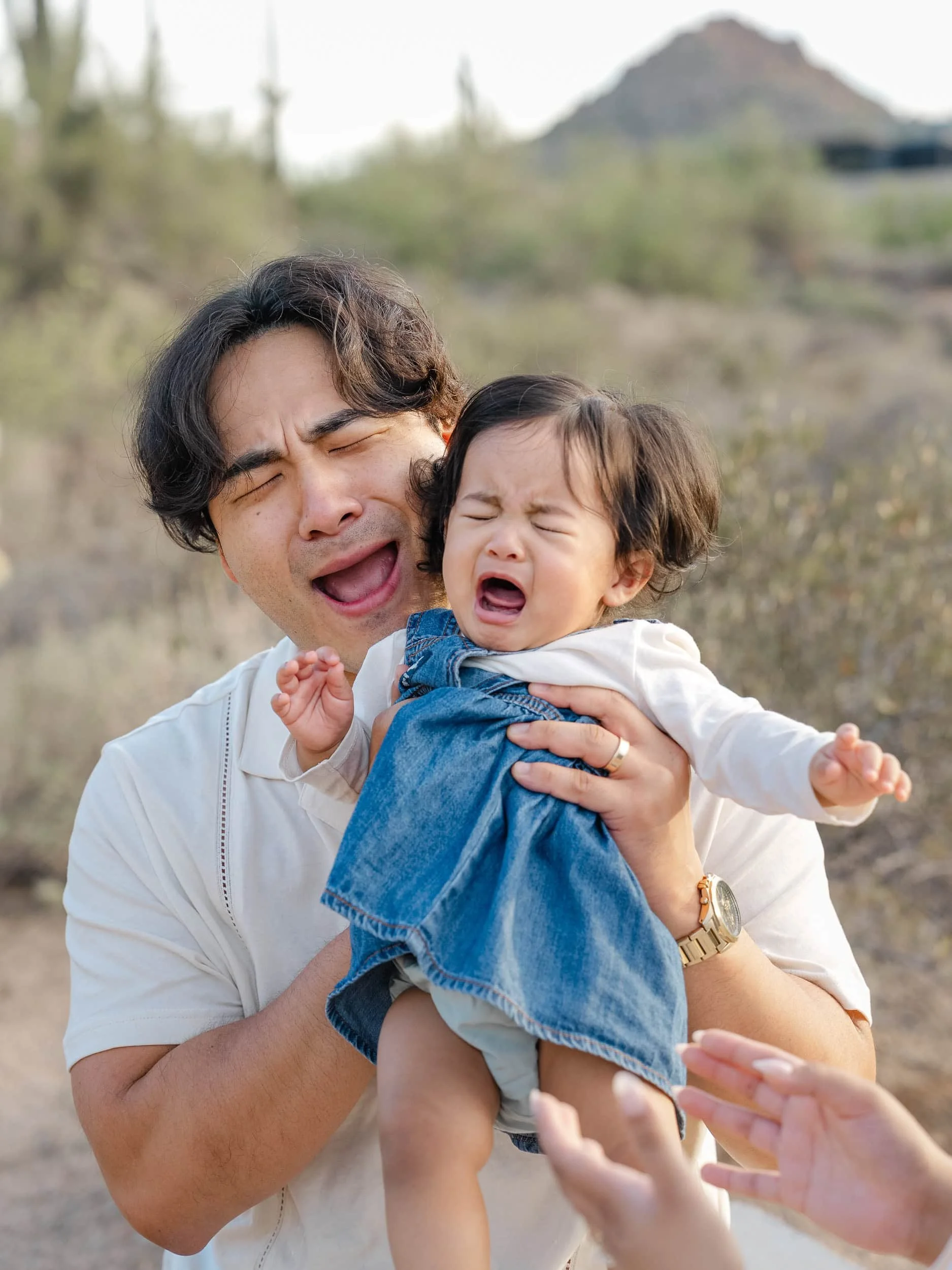 Candid of father comforting his young daughter during a Scottsdale family photo session