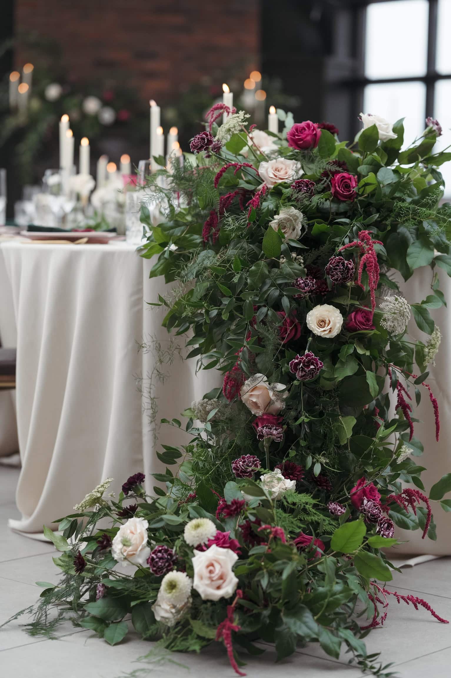 Statement floral cascading off reception table