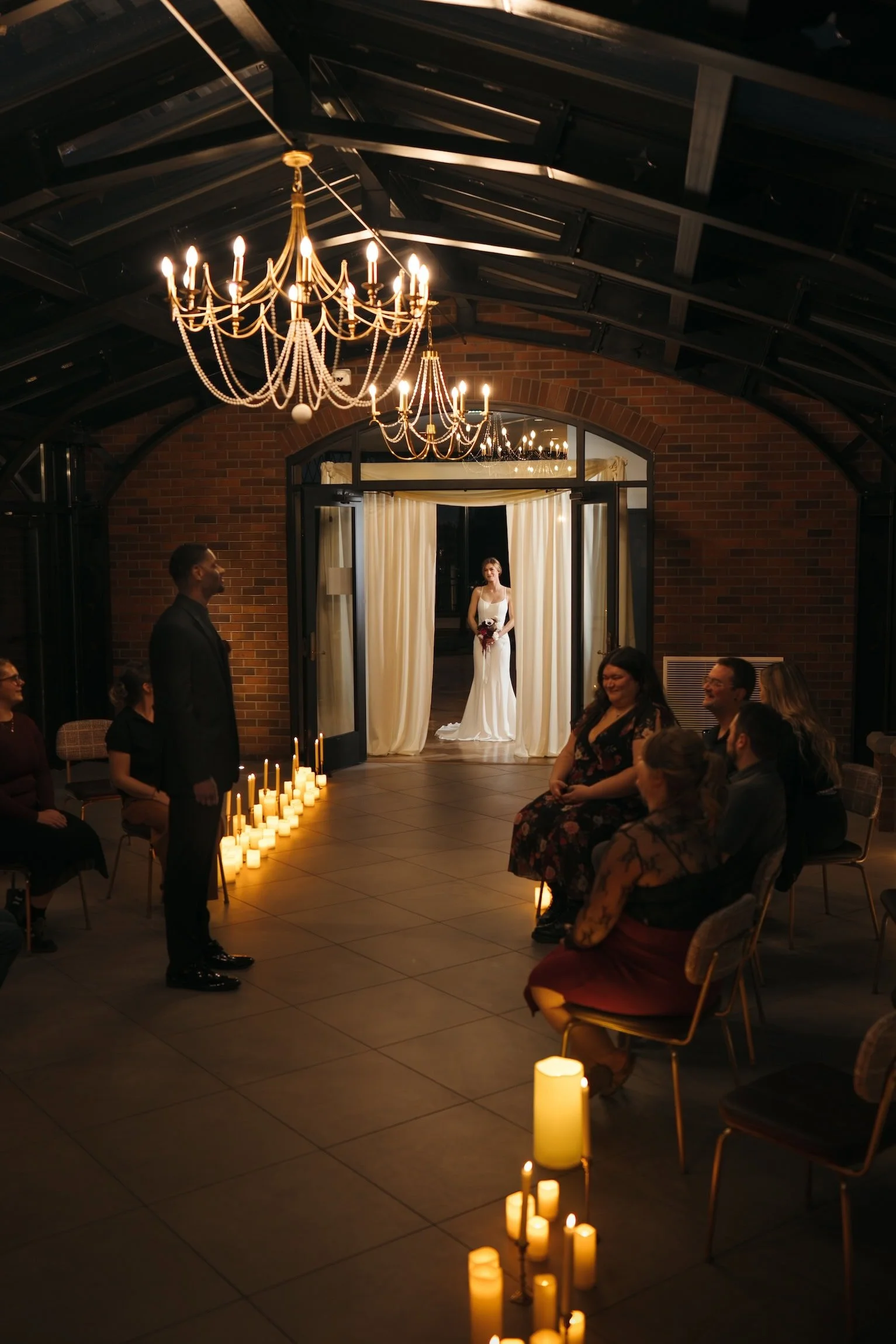 Bride waiting to enter the candlelit ceremony