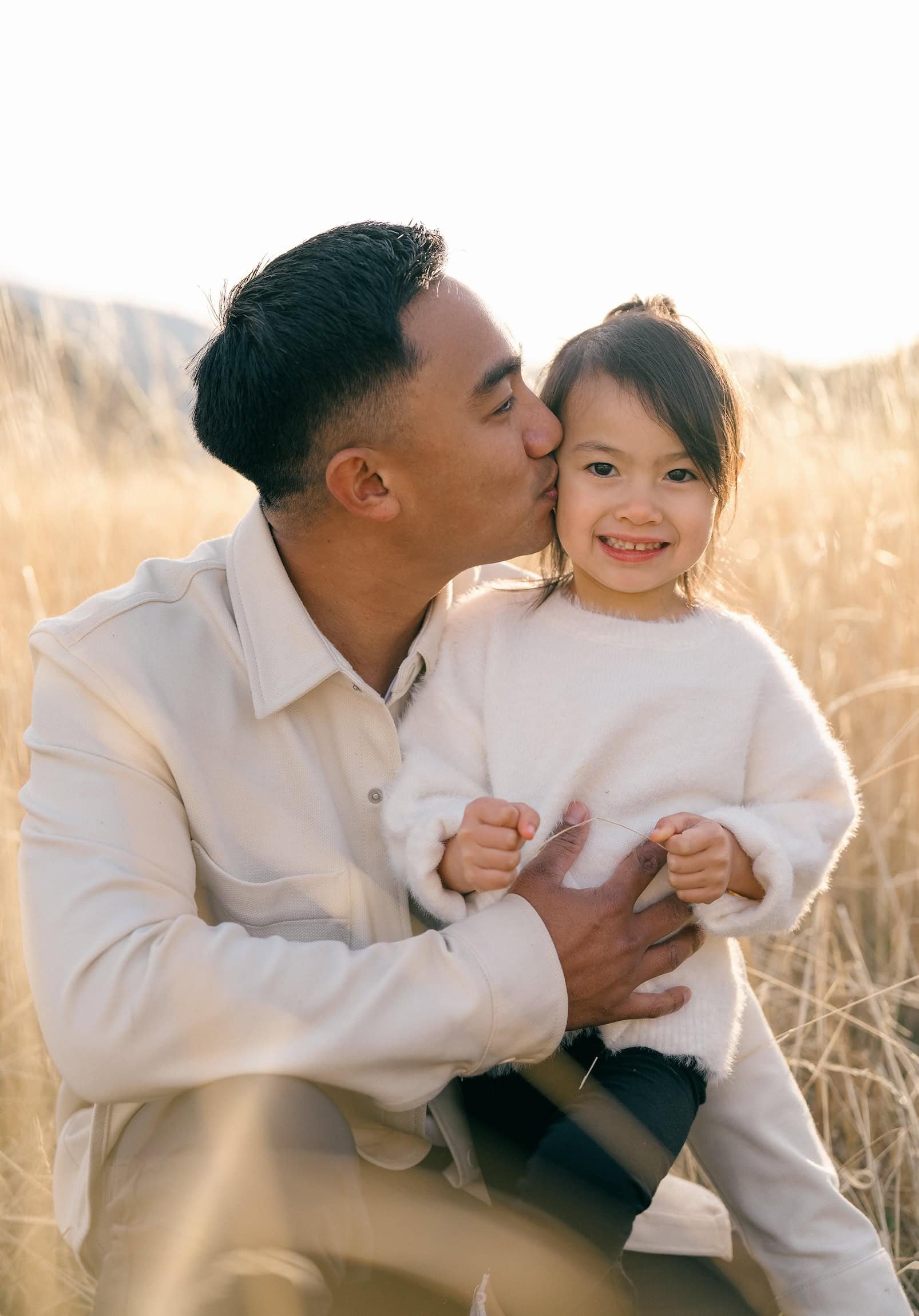Dad and daughter posing for a professional family photo in Flagstaff Arizona