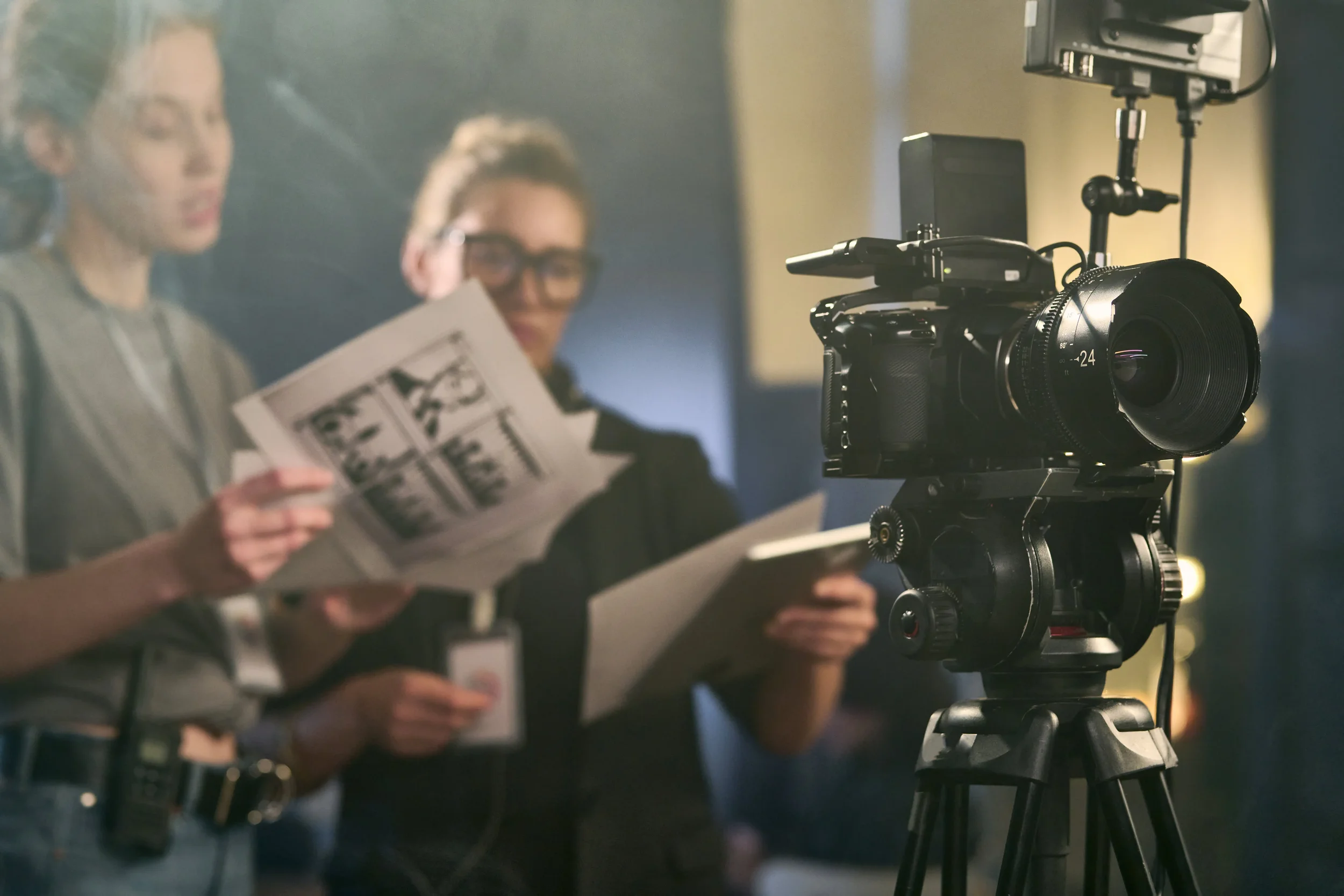 Female Director reviewing script in a professional studio before filming for a purpose-driven organisation